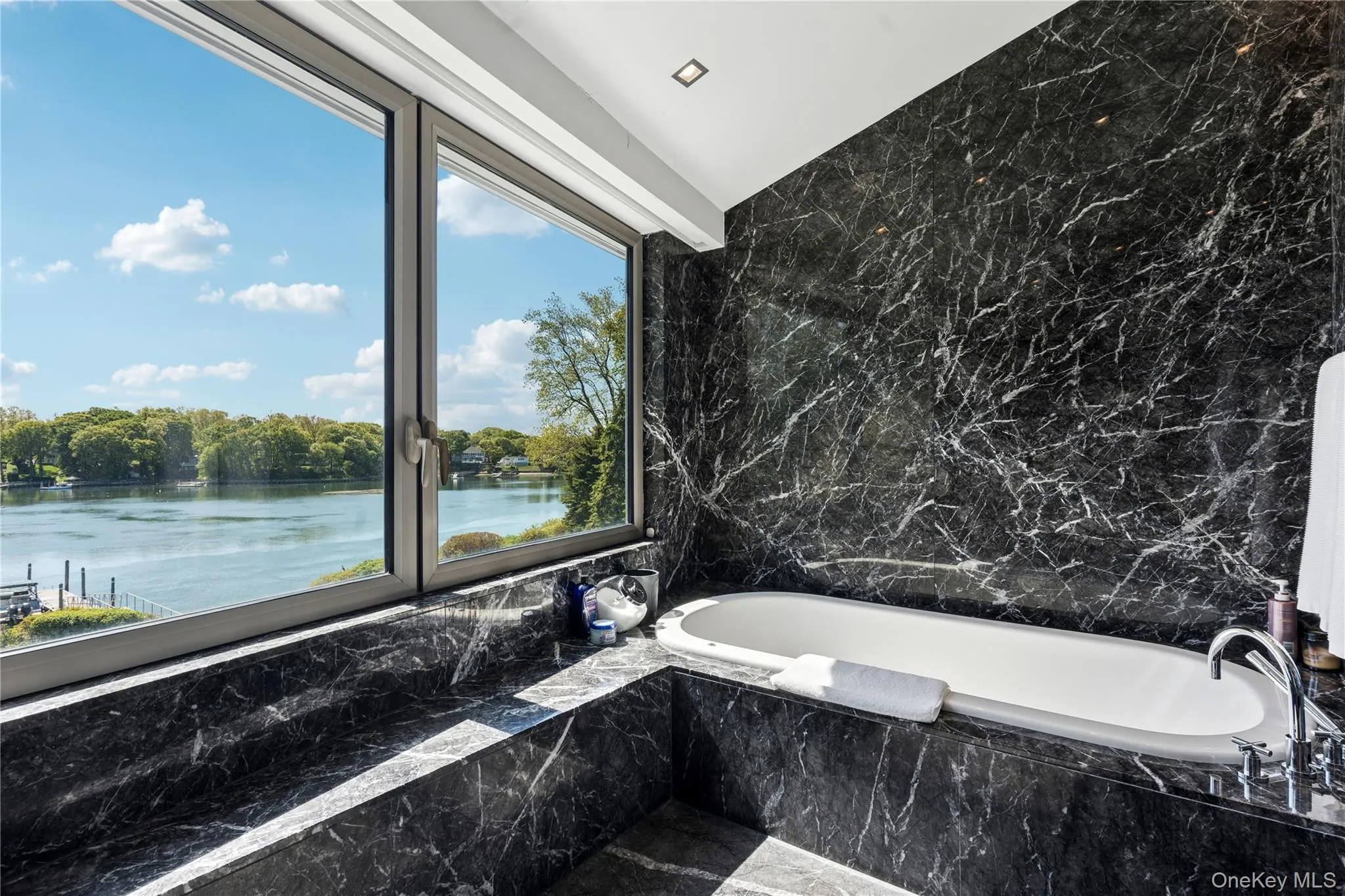 Primary Bathroom w/ Soaker Tub & Views of the Water Primary Bathroom w/ Soaker Tub & Views of the Water
