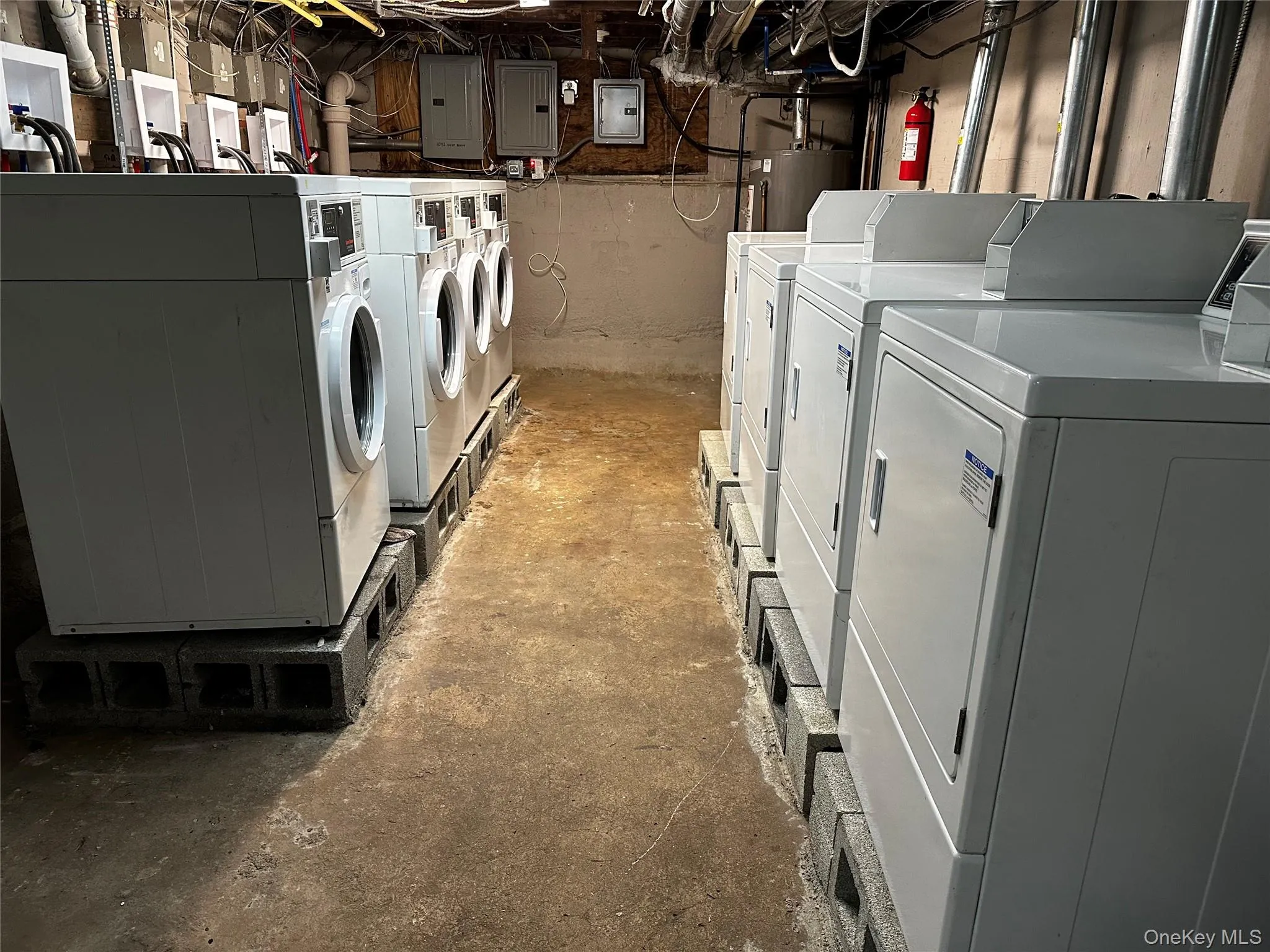 Washroom featuring electric panel and washing machine and clothes dryer Washroom featuring electric panel and washing machine and clothes dryer