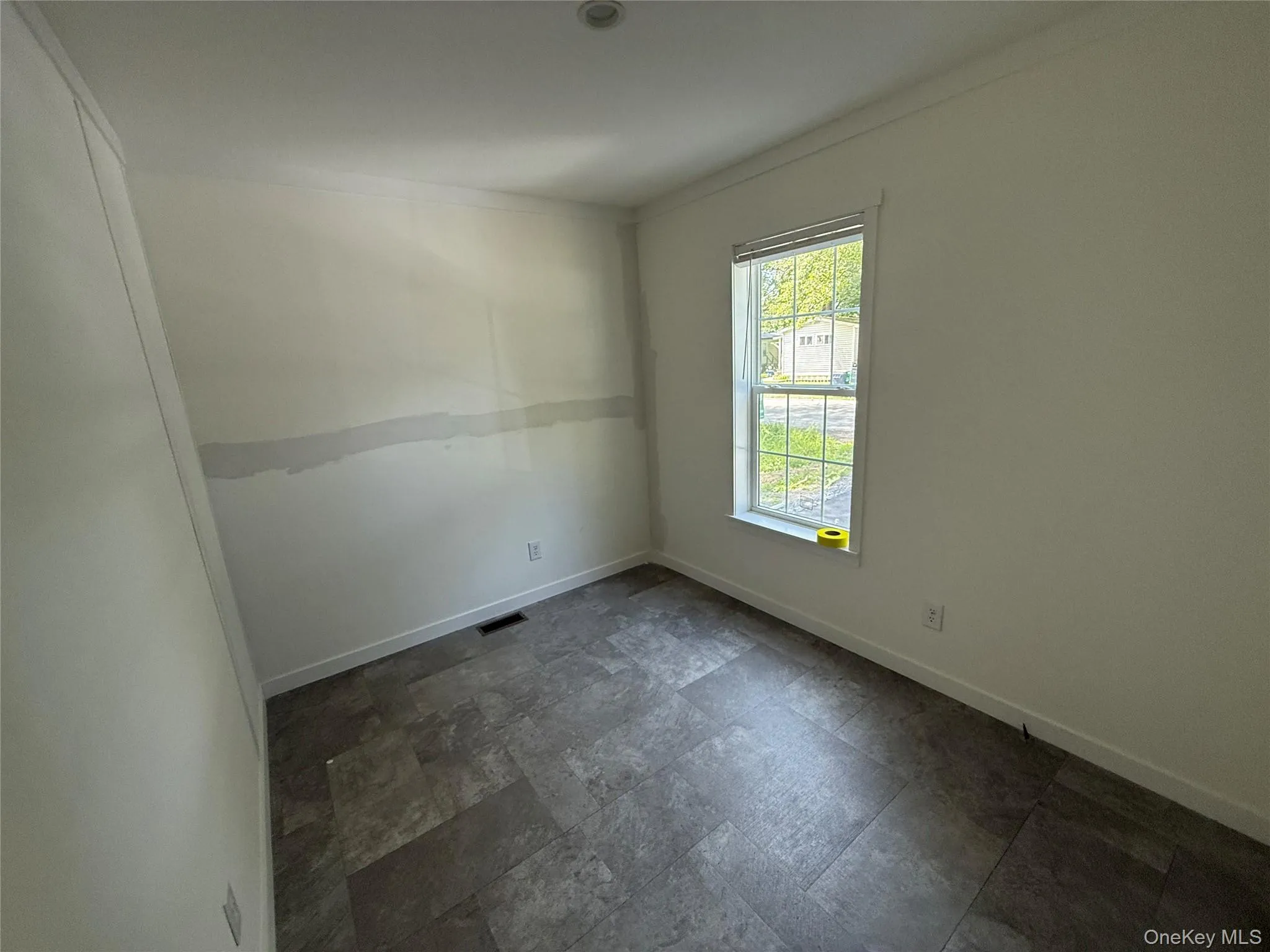 Empty room with stone finish flooring and ornamental molding Empty room with stone finish flooring and ornamental molding