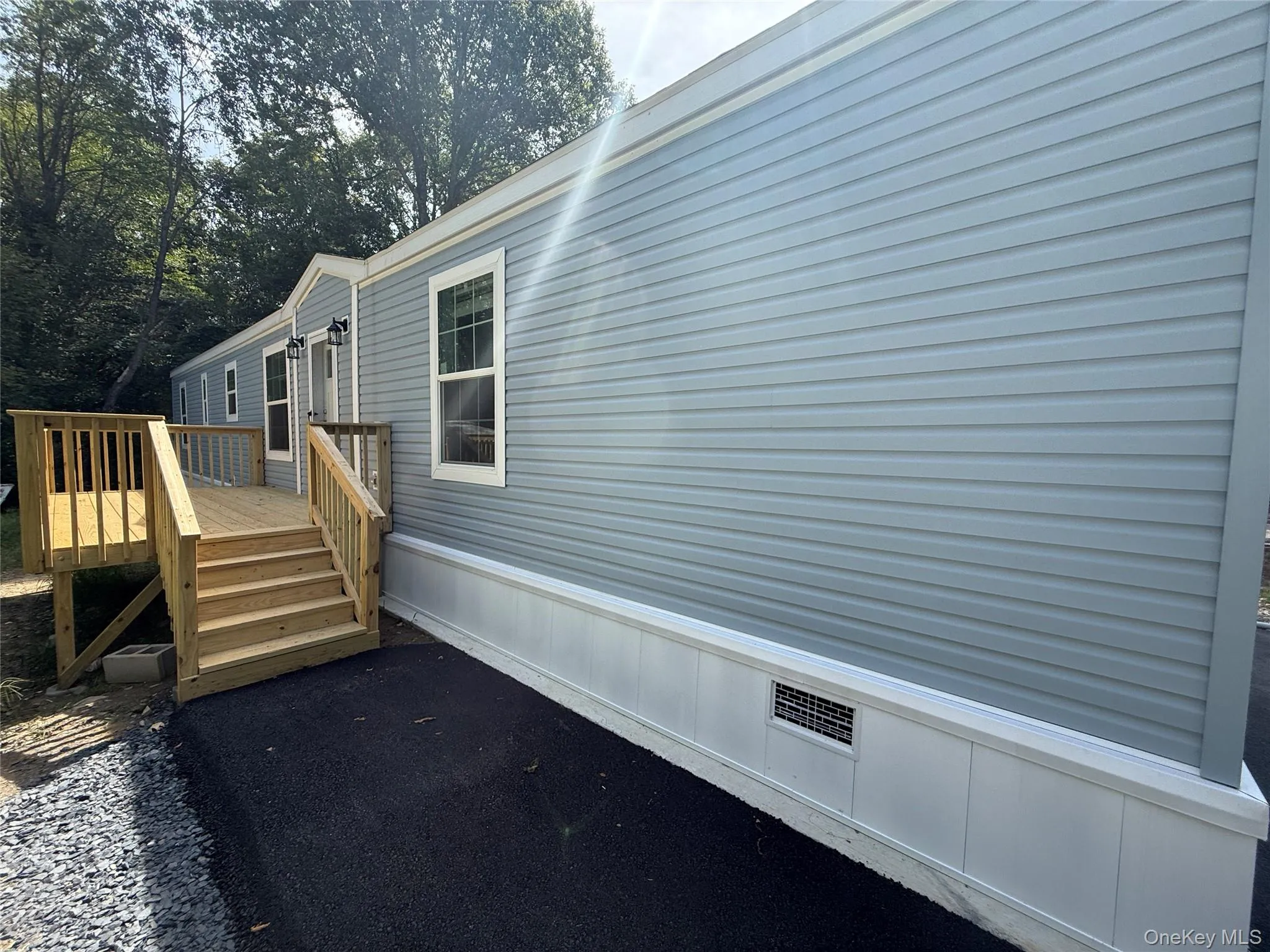 View of property exterior featuring a wooden deck View of property exterior featuring a wooden deck