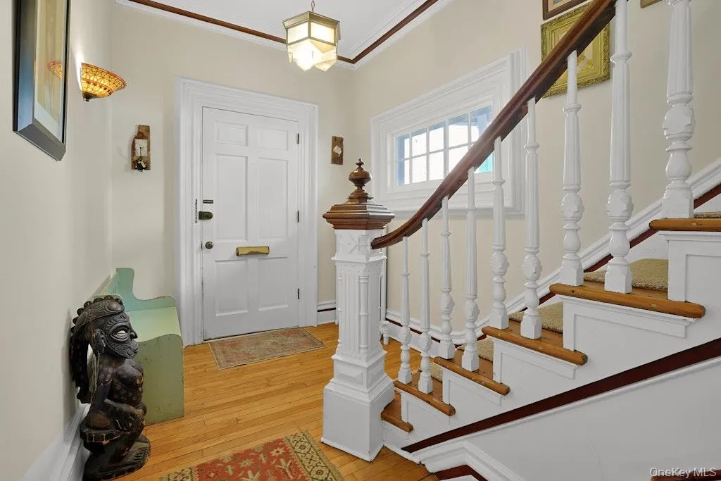 Warm and welcoming entry way with dramatic curved staircase banister Warm and welcoming entry way with dramatic curved staircase banister