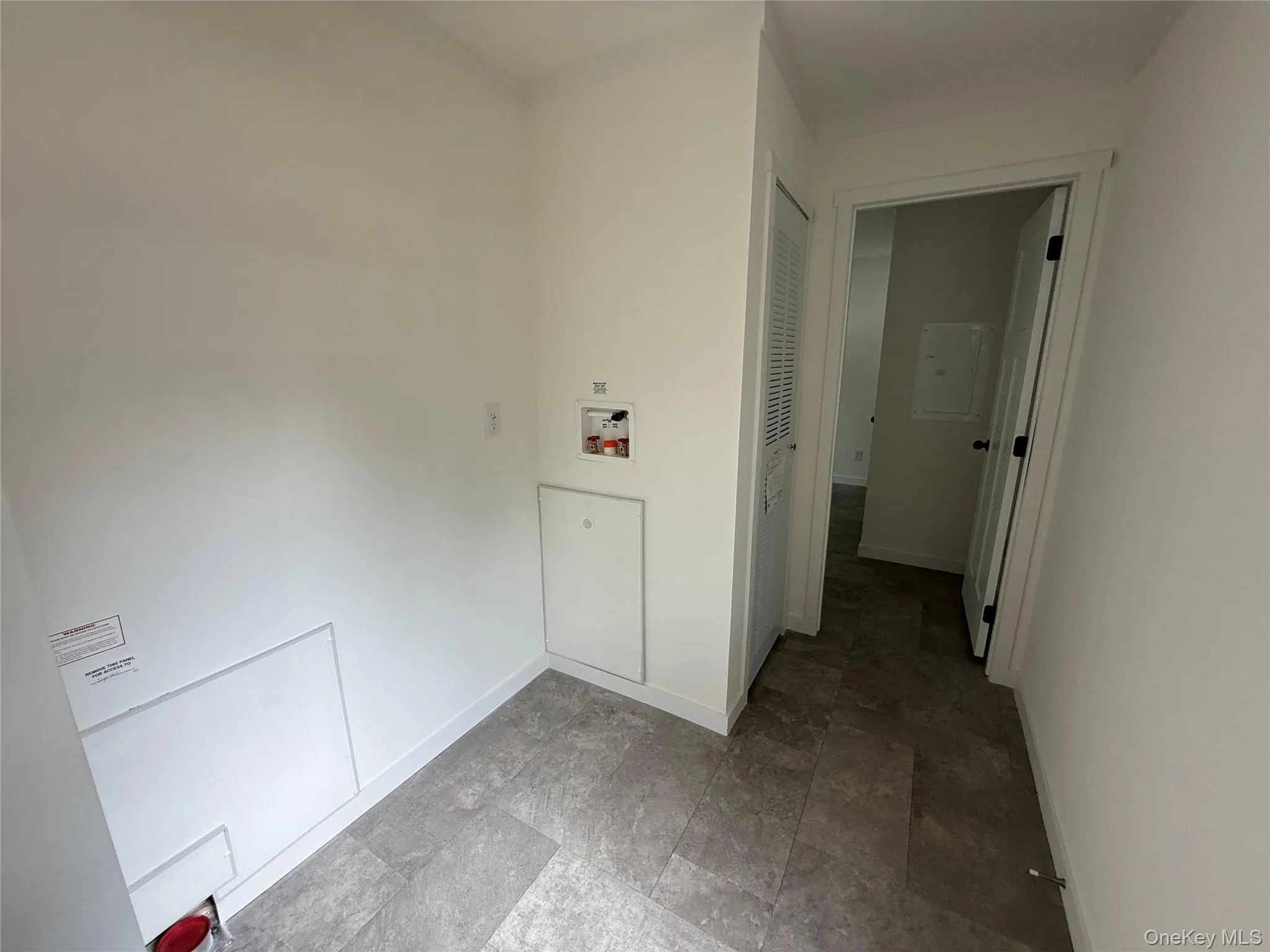 Laundry area with baseboards and washer hookup Laundry area with baseboards and washer hookup