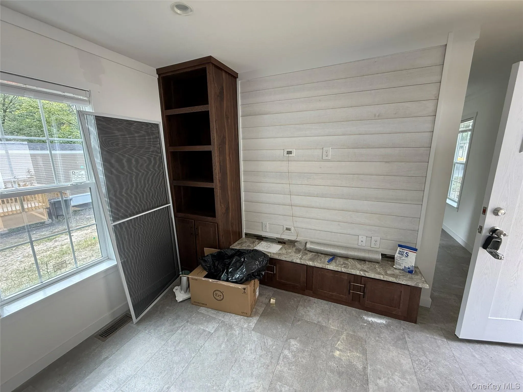 Mudroom with wood walls and baseboards Mudroom with wood walls and baseboards