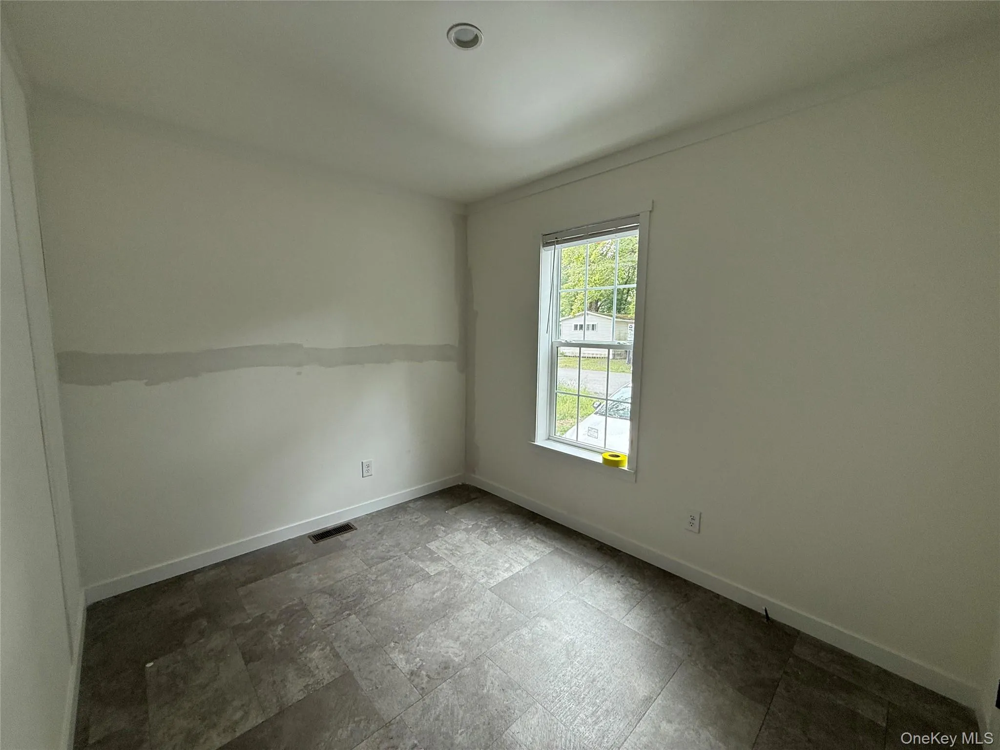 Unfurnished room with stone finish floors and baseboards Unfurnished room with stone finish floors and baseboards