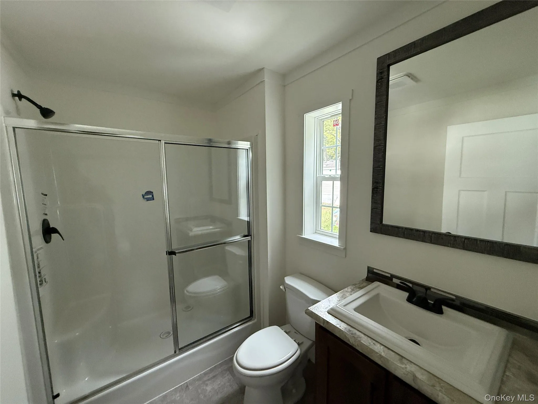 Full bathroom featuring a shower stall and vanity Full bathroom featuring a shower stall and vanity