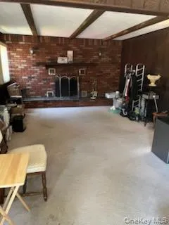 Brick fireplace with a dark wood mantel and a decorative fire screen Brick fireplace with a dark wood mantel and a decorative fire screen