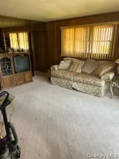 Large den for family and friends fireplace with wood mantle and paneling Large den for family and friends fireplace with wood mantle and paneling