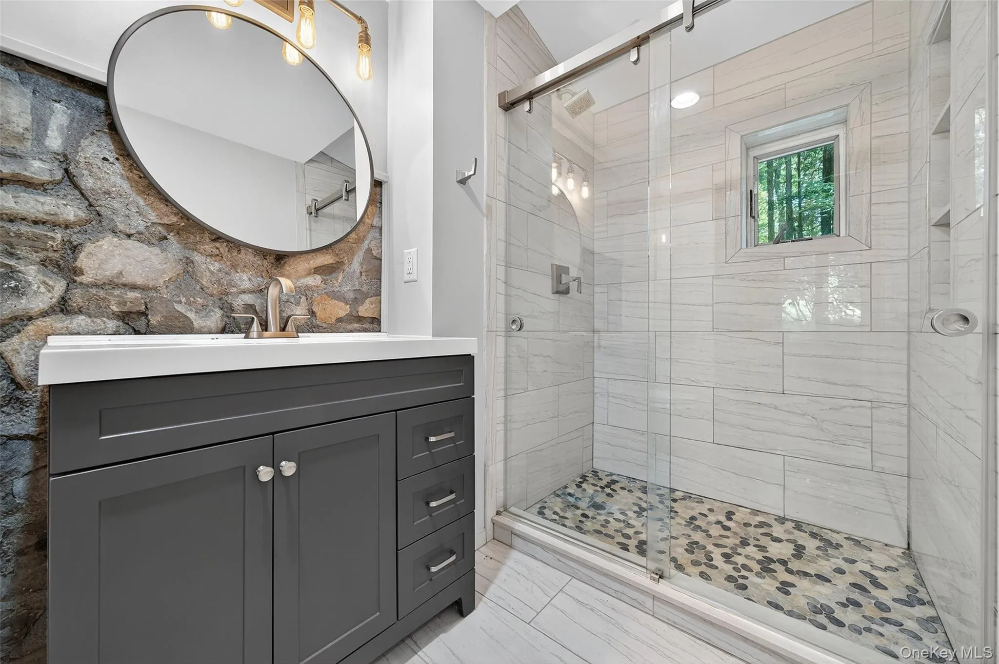 Bathroom with vanity and a shower stall Bathroom with vanity and a shower stall