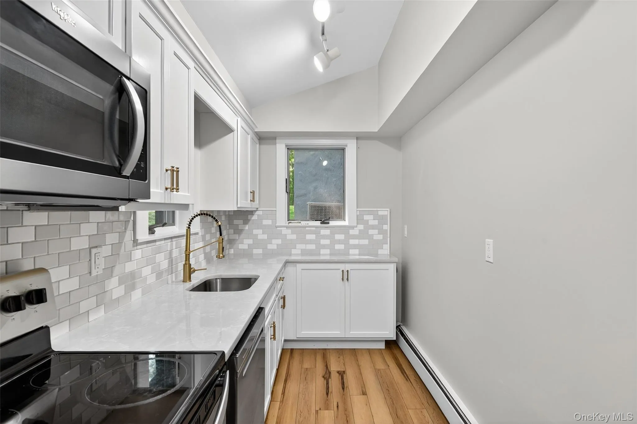 Stainless steel appliances, white cabinetry and quartz counter tops Stainless steel appliances, white cabinetry and quartz counter tops
