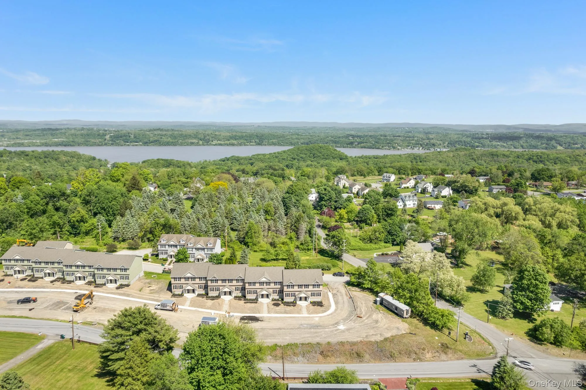 Bird's eye view of a heavily wooded area and a nearby body of water Bird's eye view of a heavily wooded area and a nearby body of water