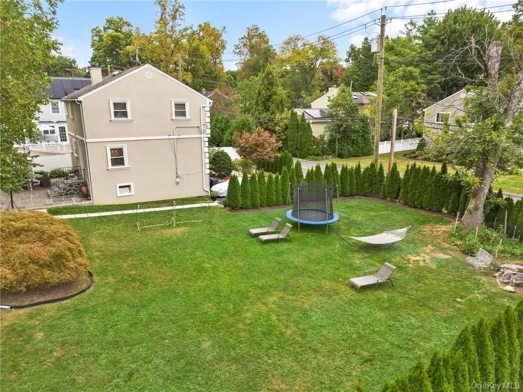 View of yard featuring a trampoline and a patio View of yard featuring a trampoline and a patio