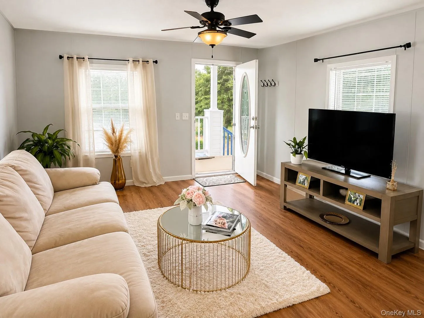 Living area with wood-finish flooring and light gray walls Living area with wood-finish flooring and light gray walls