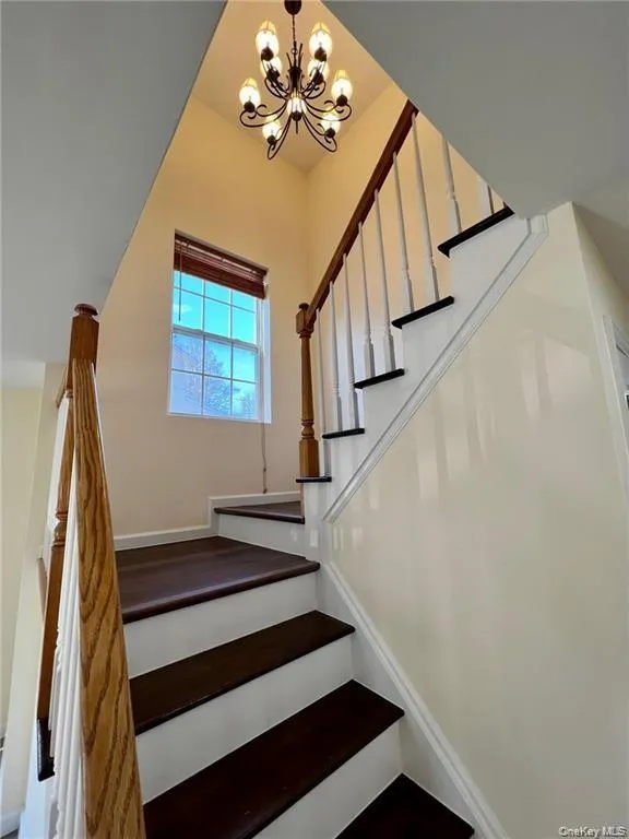 Staircase with a notable chandelier Staircase with a notable chandelier
