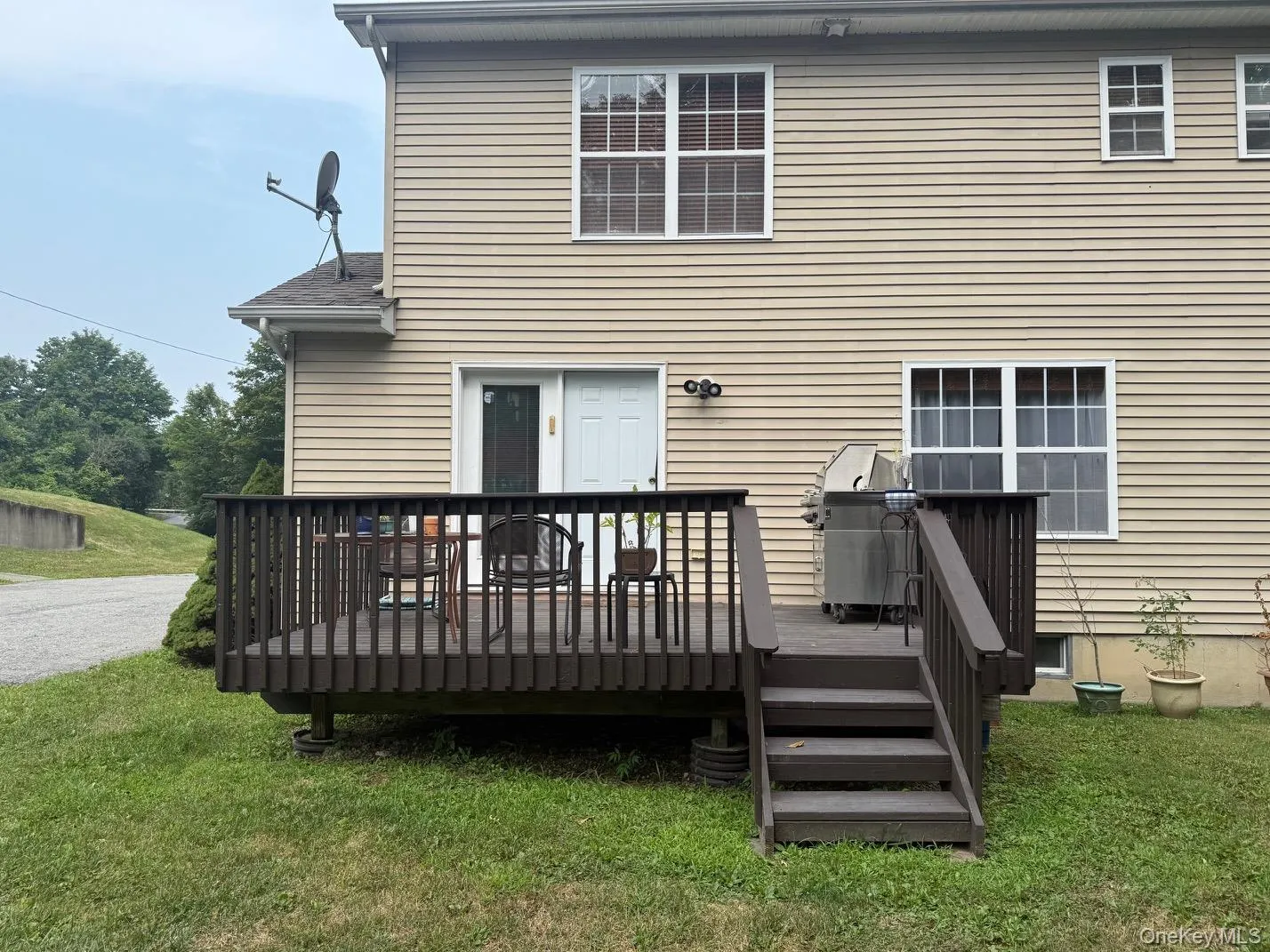 Back of house with an updated deck and a yard Back of house with an updated deck and a yard