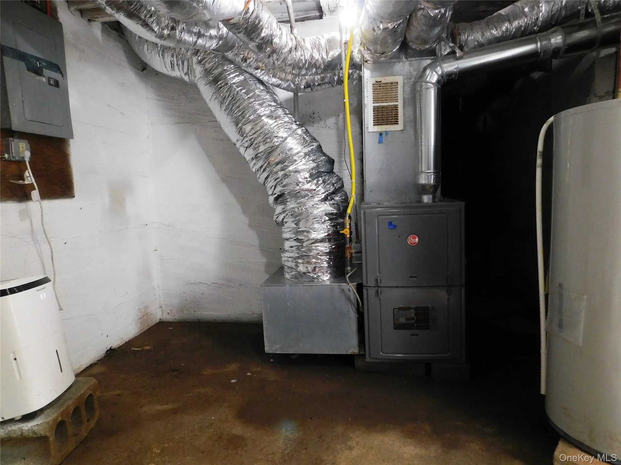 Utility room featuring a furnace, water heater, and exposed ductwork Utility room featuring a furnace, water heater, and exposed ductwork