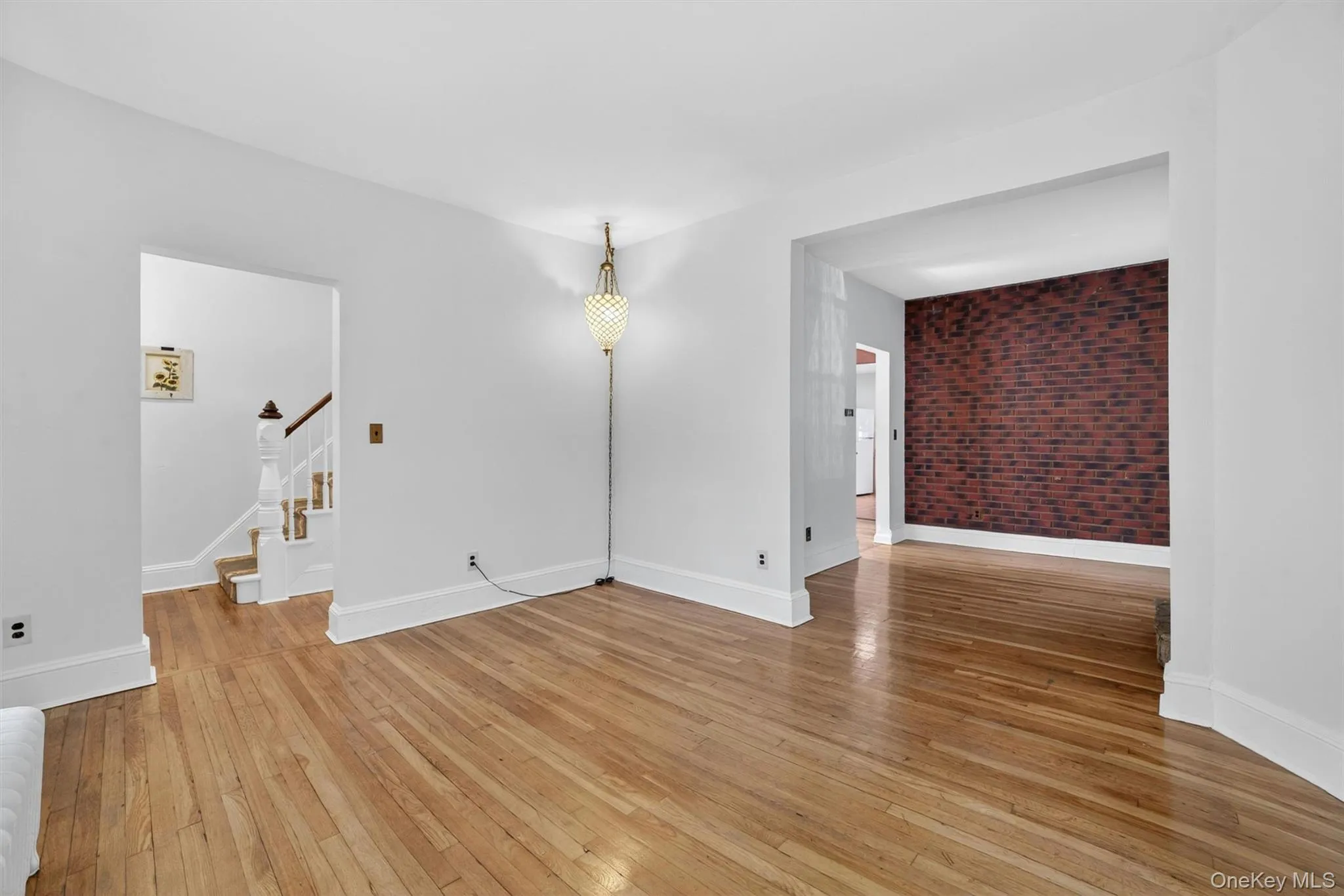 View of living room to dining room and towards front door. View of living room to dining room and towards front door.
