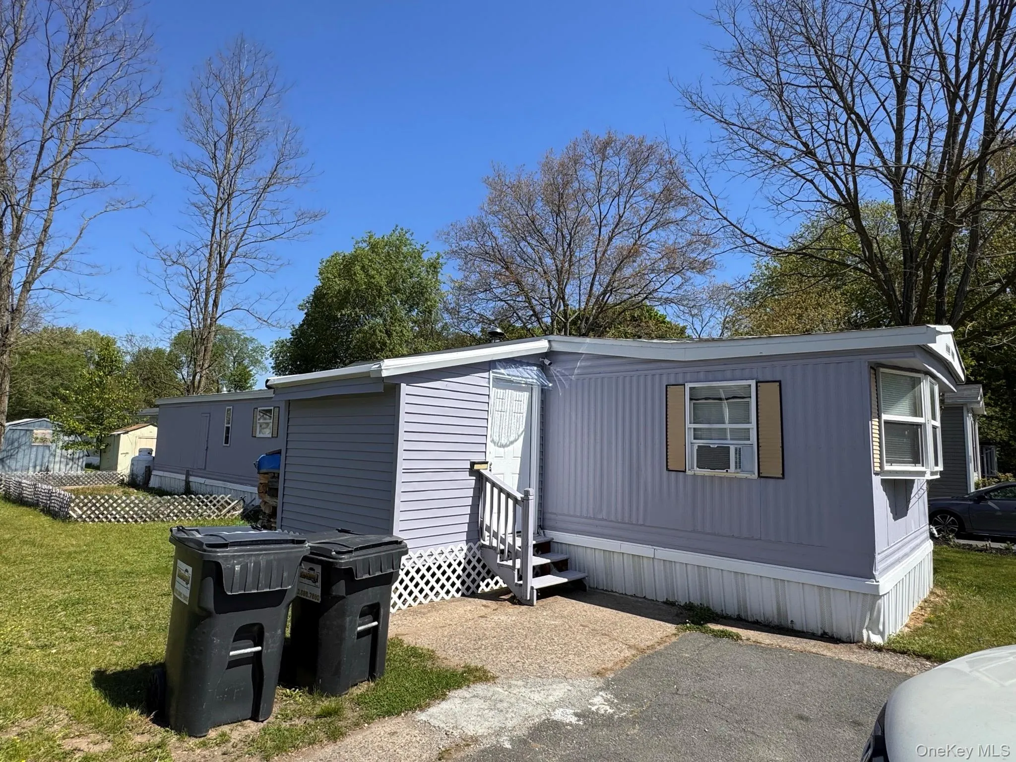 Light blue siding exterior with white trim and a white front door Light blue siding exterior with white trim and a white front door