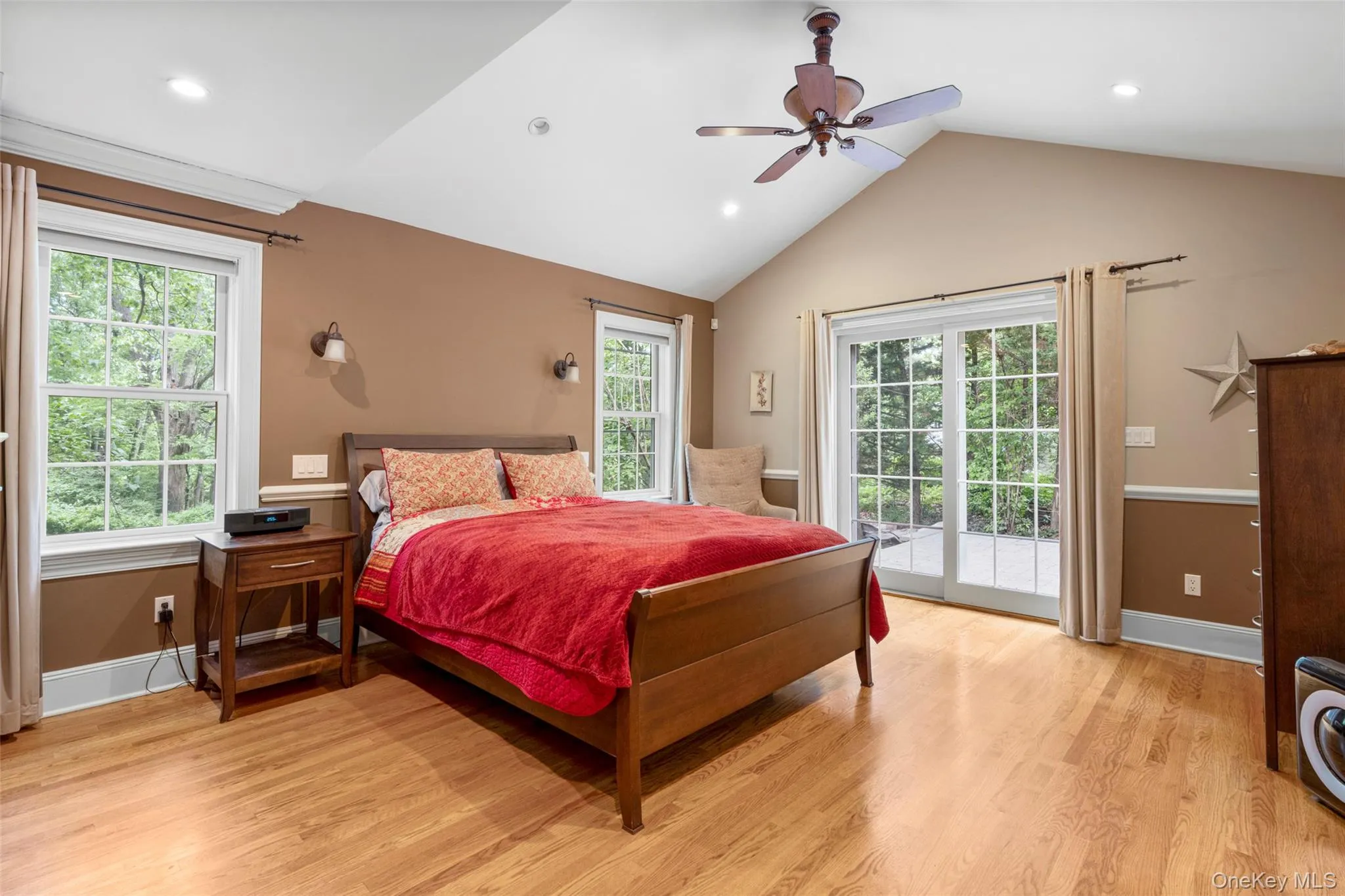 Large primary Bedroom with doors to patio Large primary Bedroom with doors to patio