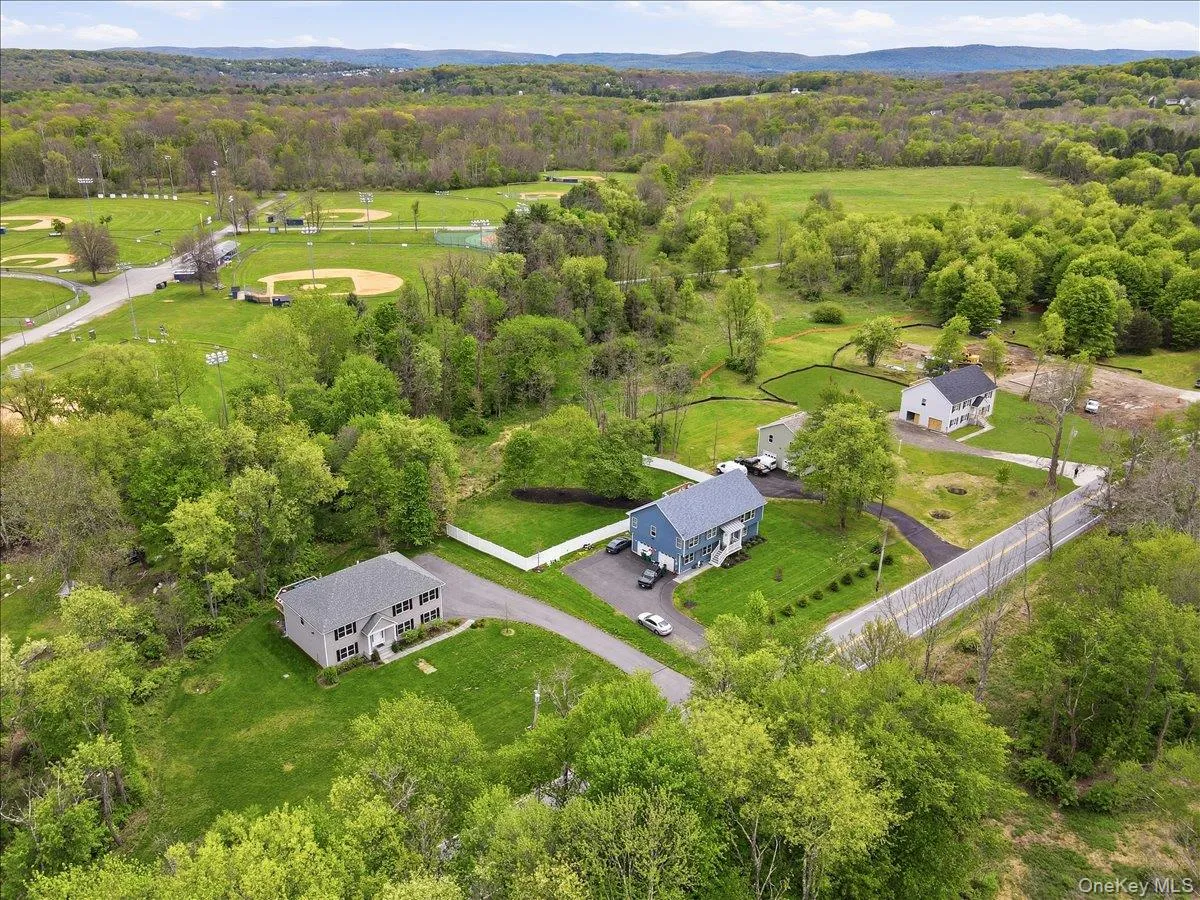 Lot 11 is located across the road from the gray home shown on the left side of the photo. Lot 11 is located across the road from the gray home shown on the left side of the photo.