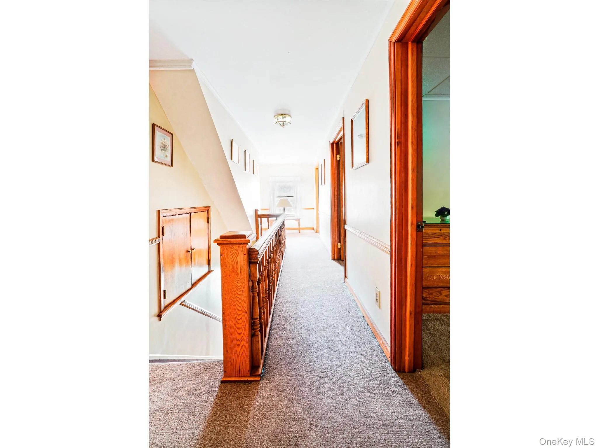 Hall featuring carpet and an upstairs landing Hall featuring carpet and an upstairs landing