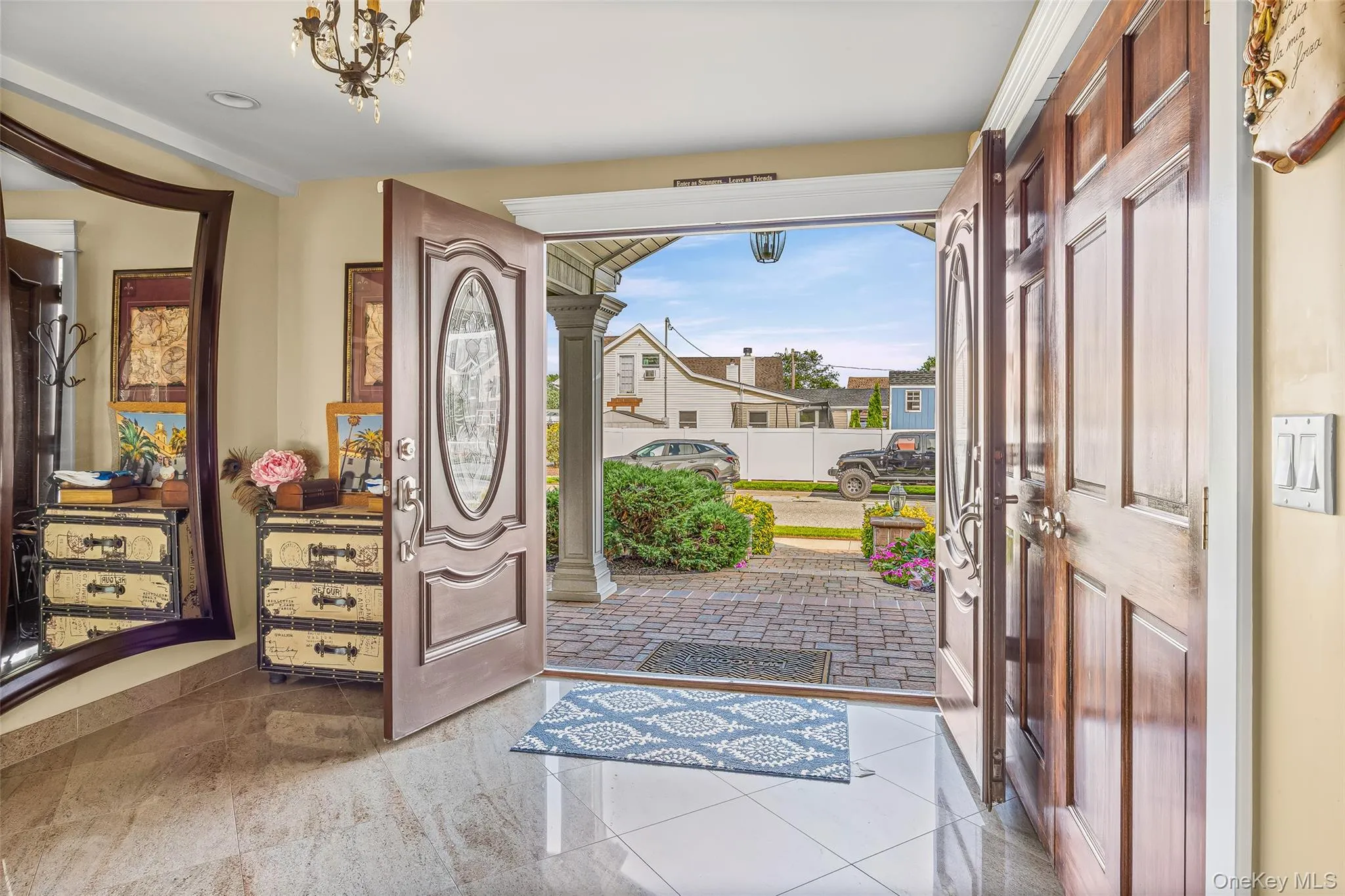 Foyer entrance with ornate columns and tile patterned floors Foyer entrance with ornate columns and tile patterned floors