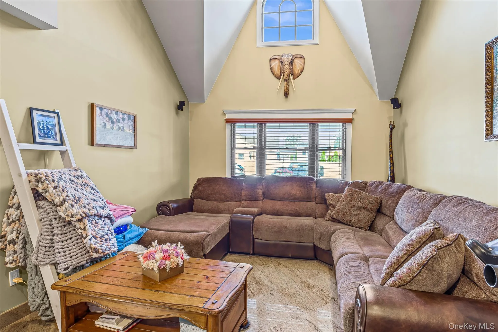 Living room featuring high vaulted ceiling Living room featuring high vaulted ceiling