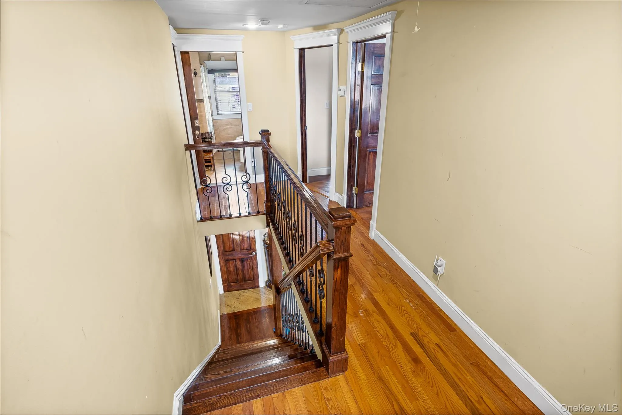 Staircase featuring wood-type flooring and baseboards Staircase featuring wood-type flooring and baseboards