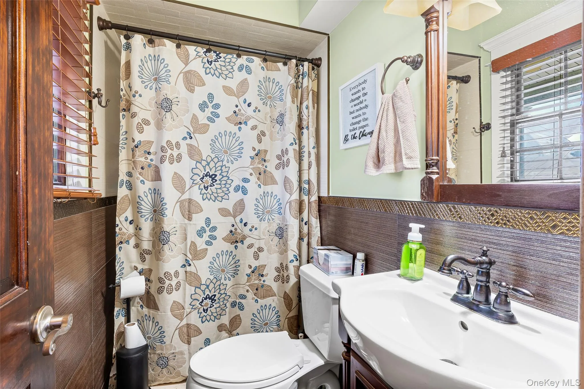 Full bath with healthy amount of natural light, vanity, and a shower with shower curtain Full bath with healthy amount of natural light, vanity, and a shower with shower curtain