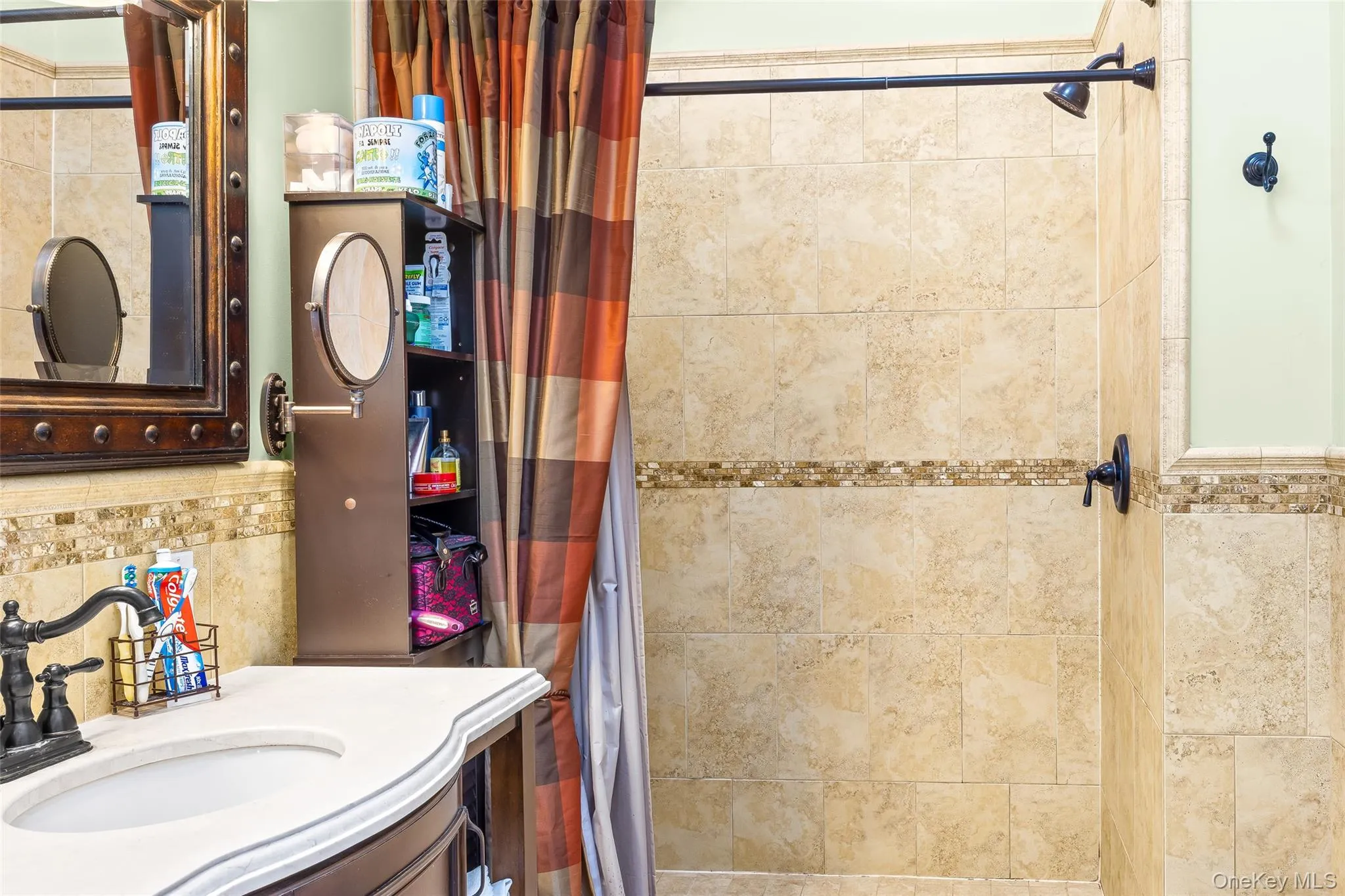 Full bath with decorative backsplash, a shower with curtain, and vanity Full bath with decorative backsplash, a shower with curtain, and vanity