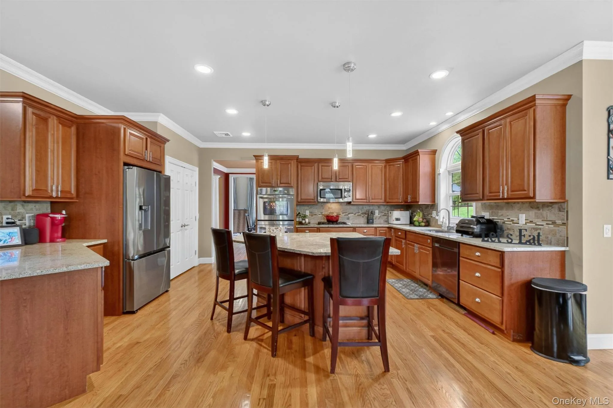 Beautifully appointed kitchen with oversized island, custom cabinetry, and generous pantry. Beautifully appointed kitchen with oversized island, custom cabinetry, and generous pantry.