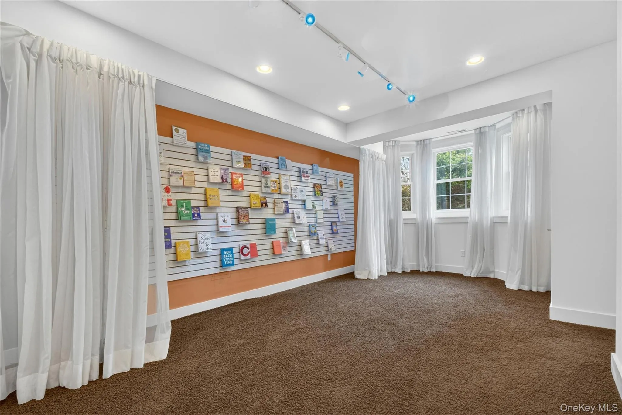 Curated display gallery with custom shelving, accent lighting, and flexible showcase potential. Curated display gallery with custom shelving, accent lighting, and flexible showcase potential.