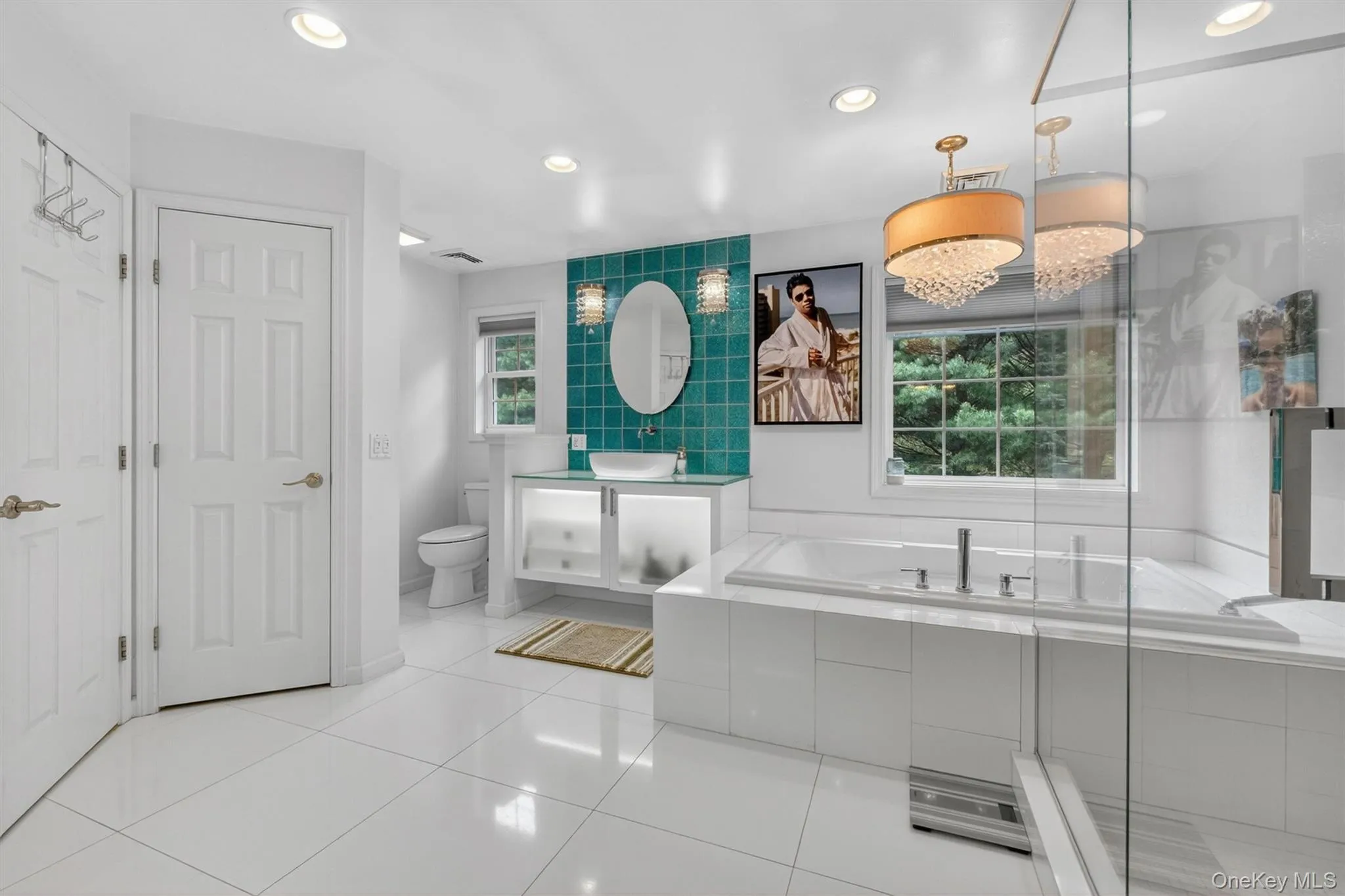 Luxurious primary bath with oversized Jacuzzi tub, multi-head glass-enclosed shower, and dual custom sinks. Luxurious primary bath with oversized Jacuzzi tub, multi-head glass-enclosed shower, and dual custom sinks.