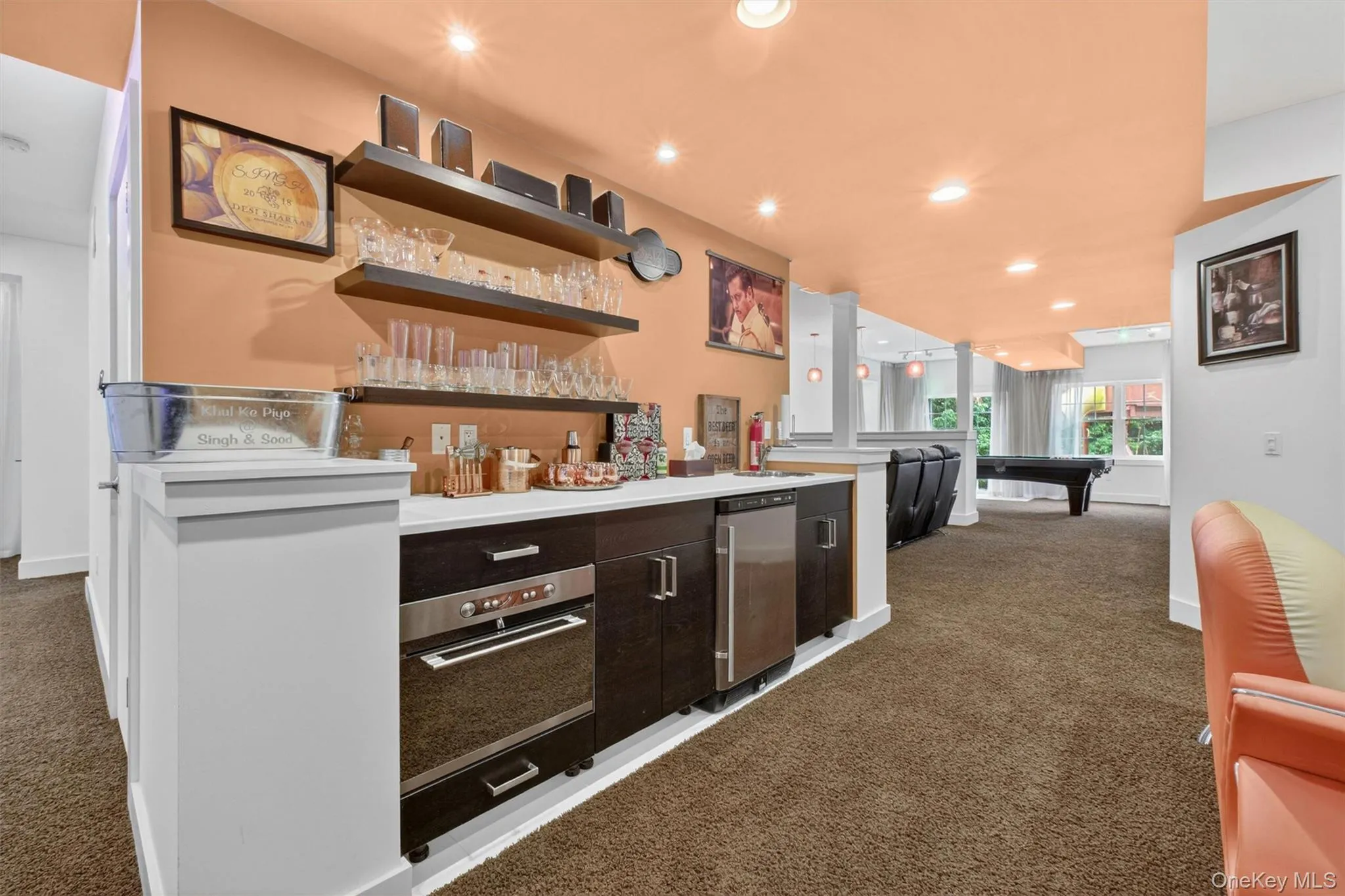 Sophisticated wet bar with custom cabinetry, sink, beverage refrigerator, and built-in microwave. Sophisticated wet bar with custom cabinetry, sink, beverage refrigerator, and built-in microwave.