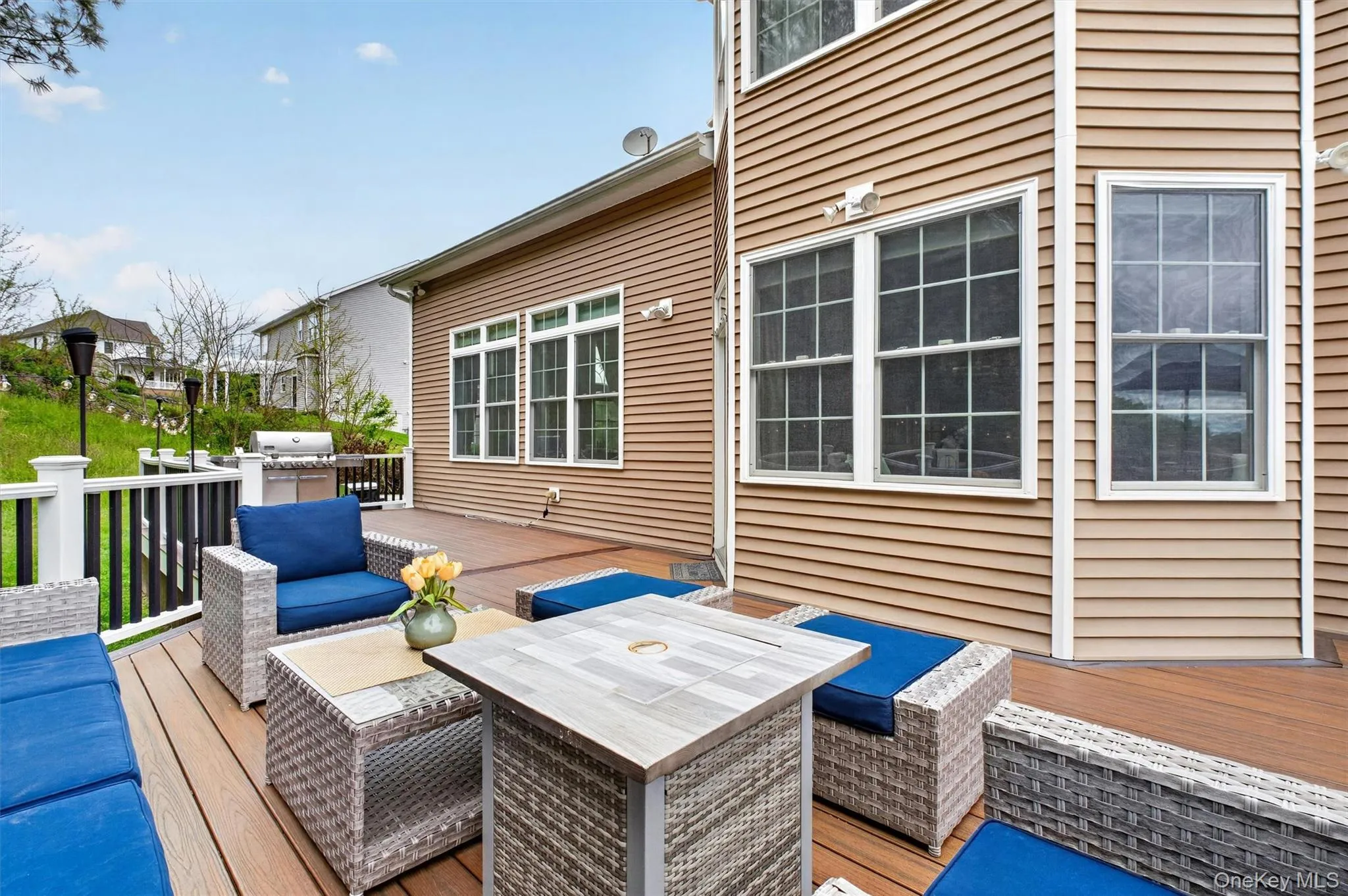 Expansive Trex deck with outdoor lounge, bar seating, natural gas grill, and generous entertaining space. Expansive Trex deck with outdoor lounge, bar seating, natural gas grill, and generous entertaining space.