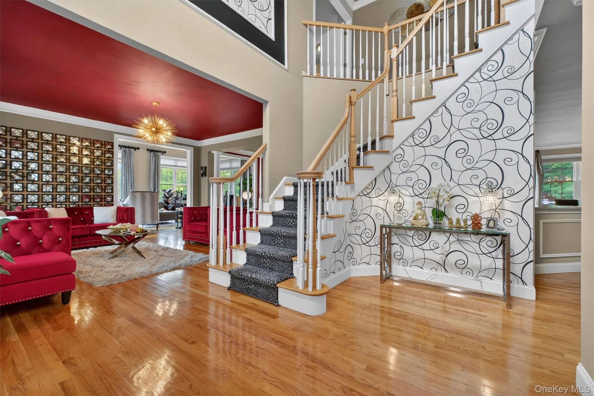 Grand foyer with soaring entry, designer finishes, and elegant dual staircase. Grand foyer with soaring entry, designer finishes, and elegant dual staircase.
