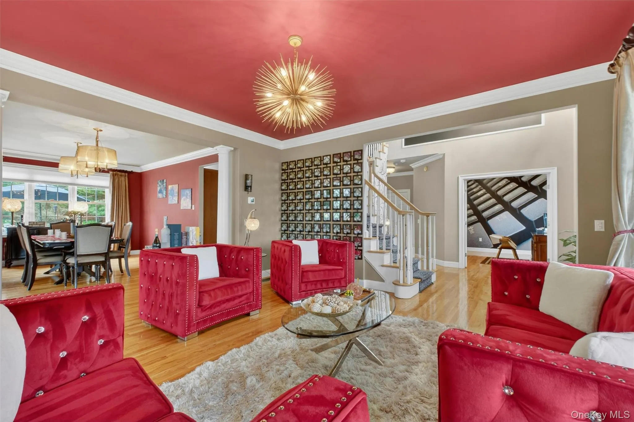 Elegant formal living room with statement lighting and dramatic custom candle-wall accents. Elegant formal living room with statement lighting and dramatic custom candle-wall accents.