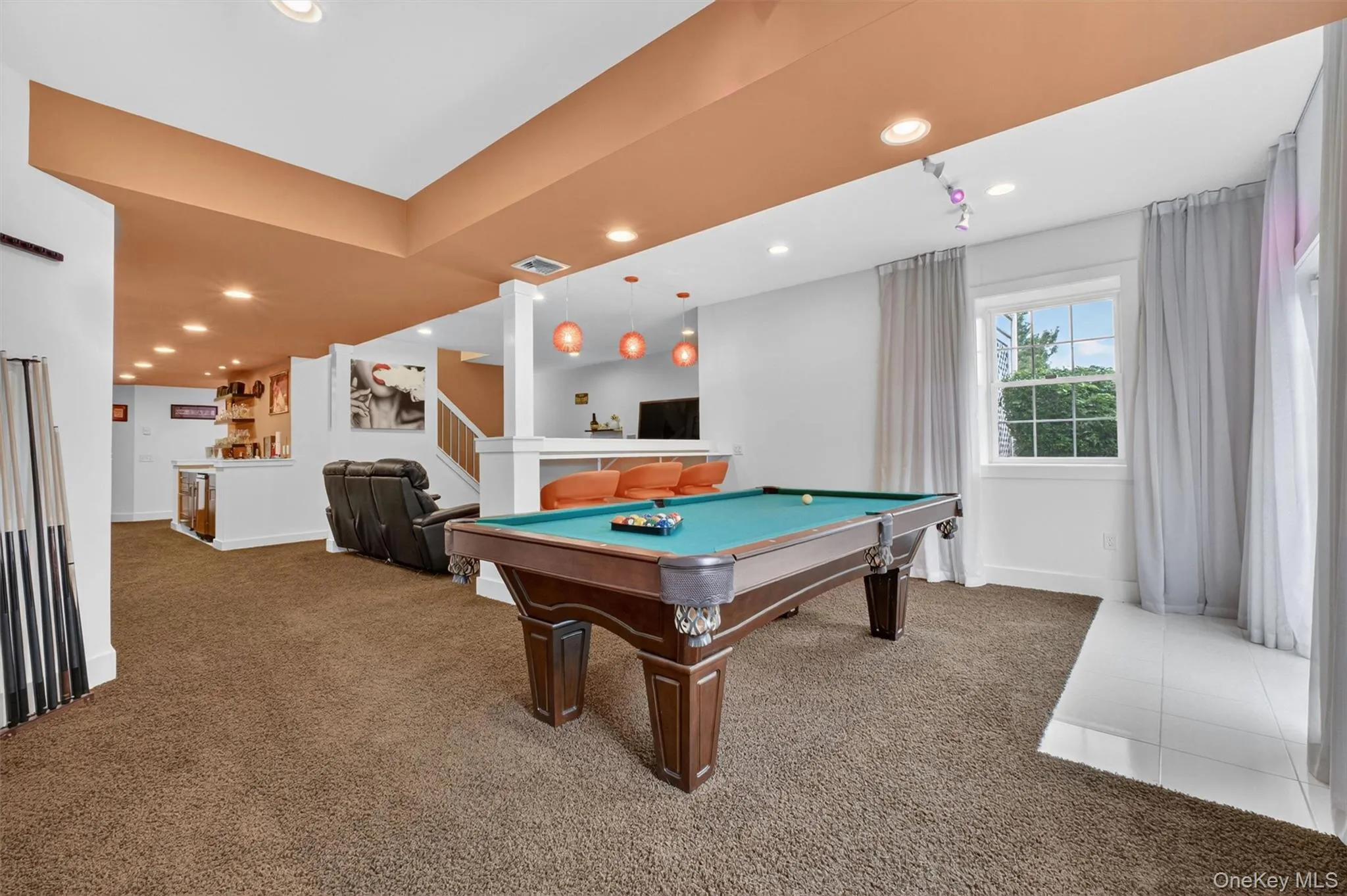 Pool lounge with bar seating, custom lighting, and open entertainment flow. Pool lounge with bar seating, custom lighting, and open entertainment flow.