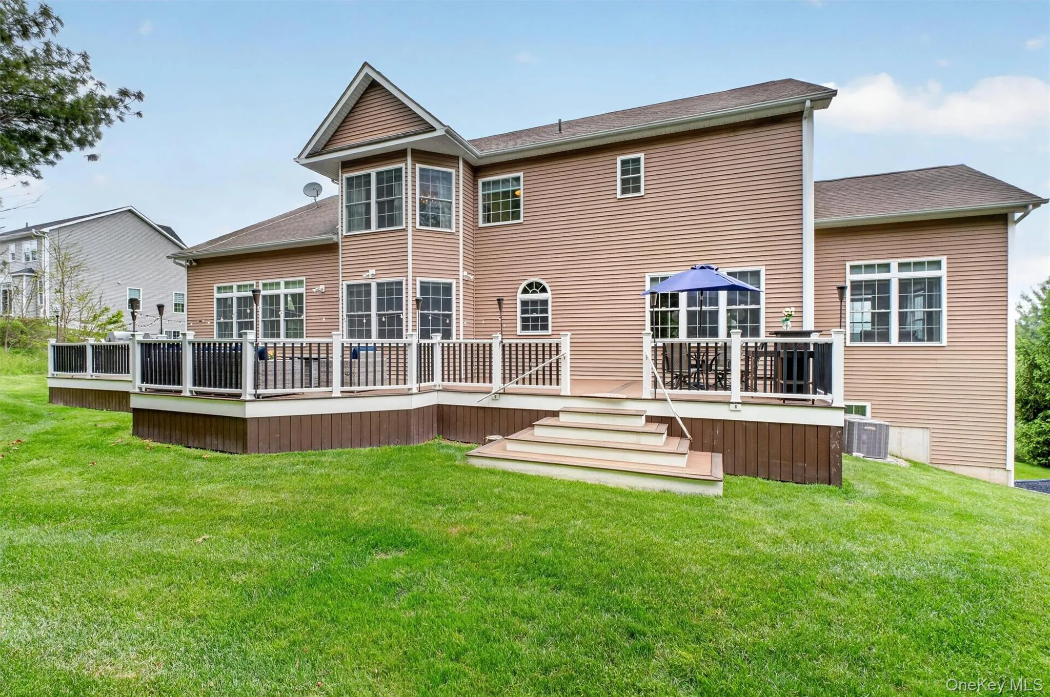 Expansive Trex deck with outdoor lounge, bar seating, natural gas grill, and generous entertaining space. Expansive Trex deck with outdoor lounge, bar seating, natural gas grill, and generous entertaining space.