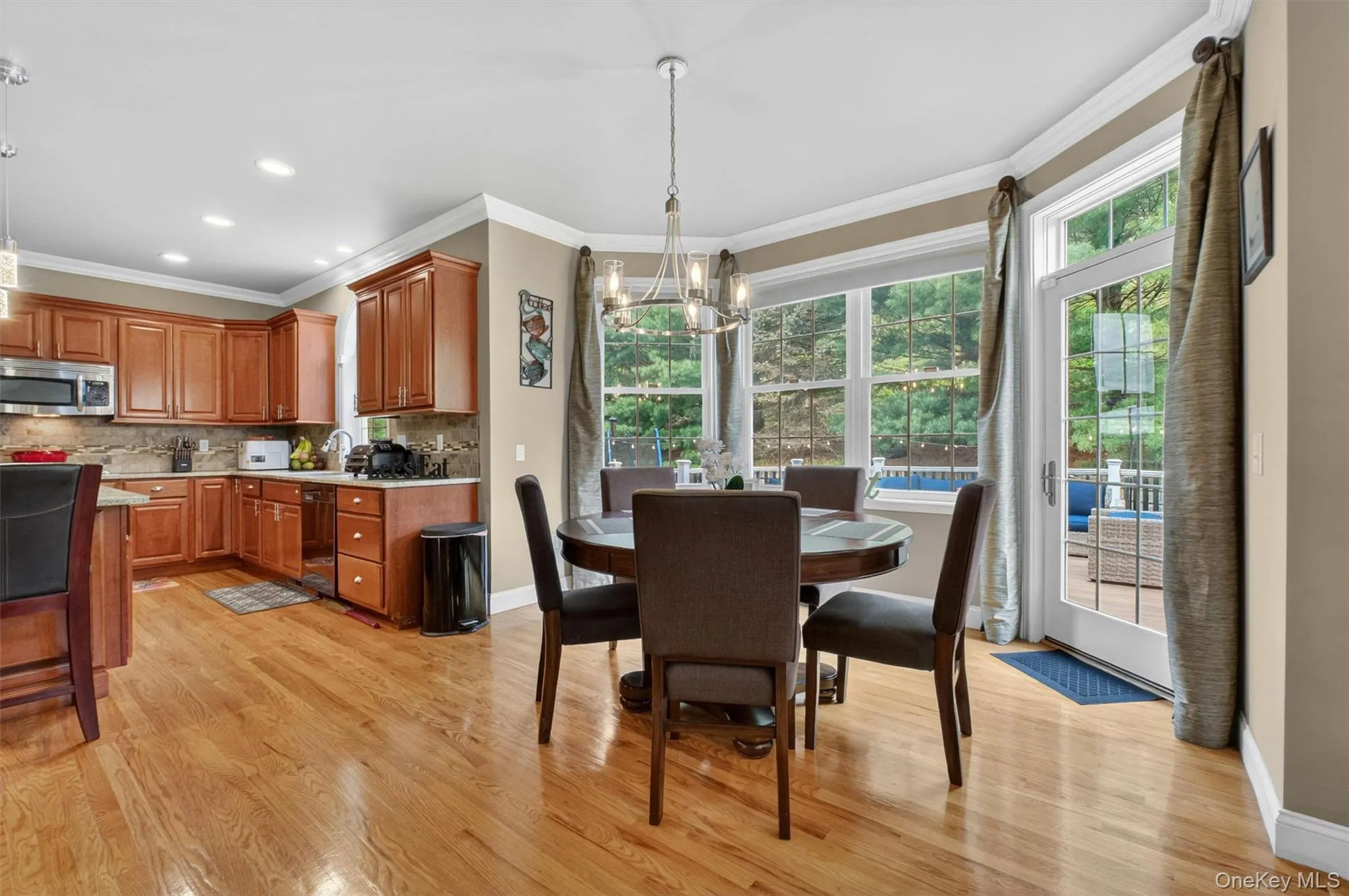 Sunlit breakfast nook with scenic windows and open flow to the family room. Sunlit breakfast nook with scenic windows and open flow to the family room.