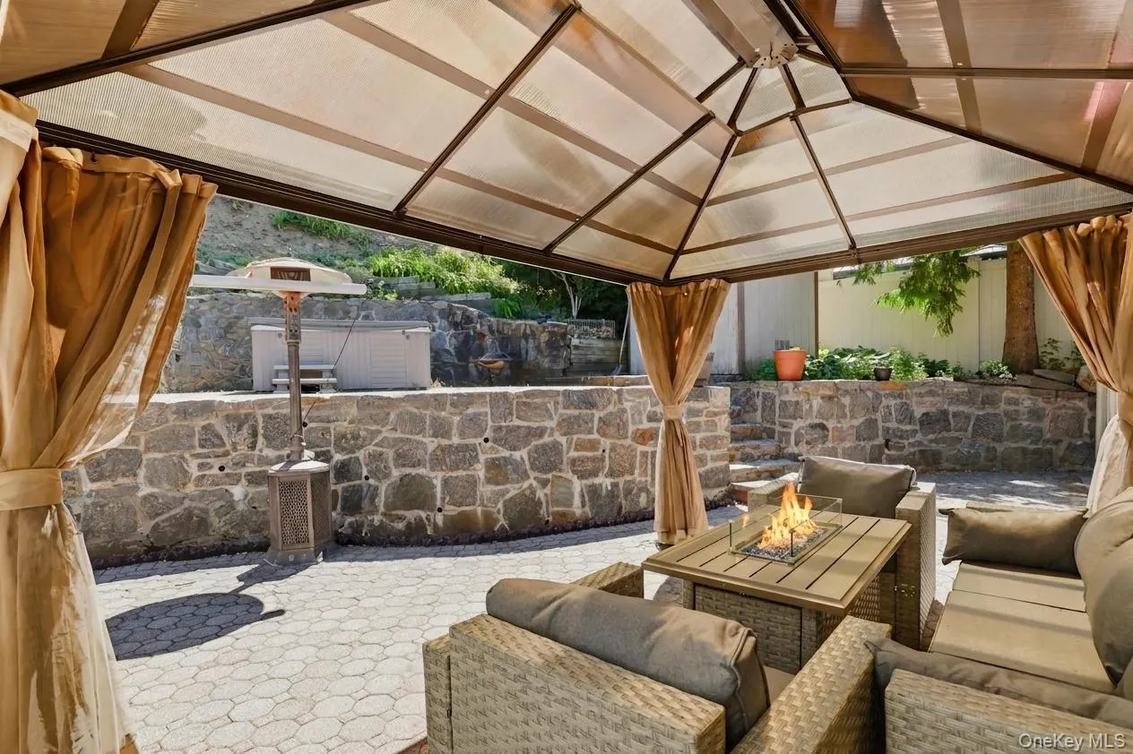 Covered patio with a translucent roof and stone paver flooring Covered patio with a translucent roof and stone paver flooring