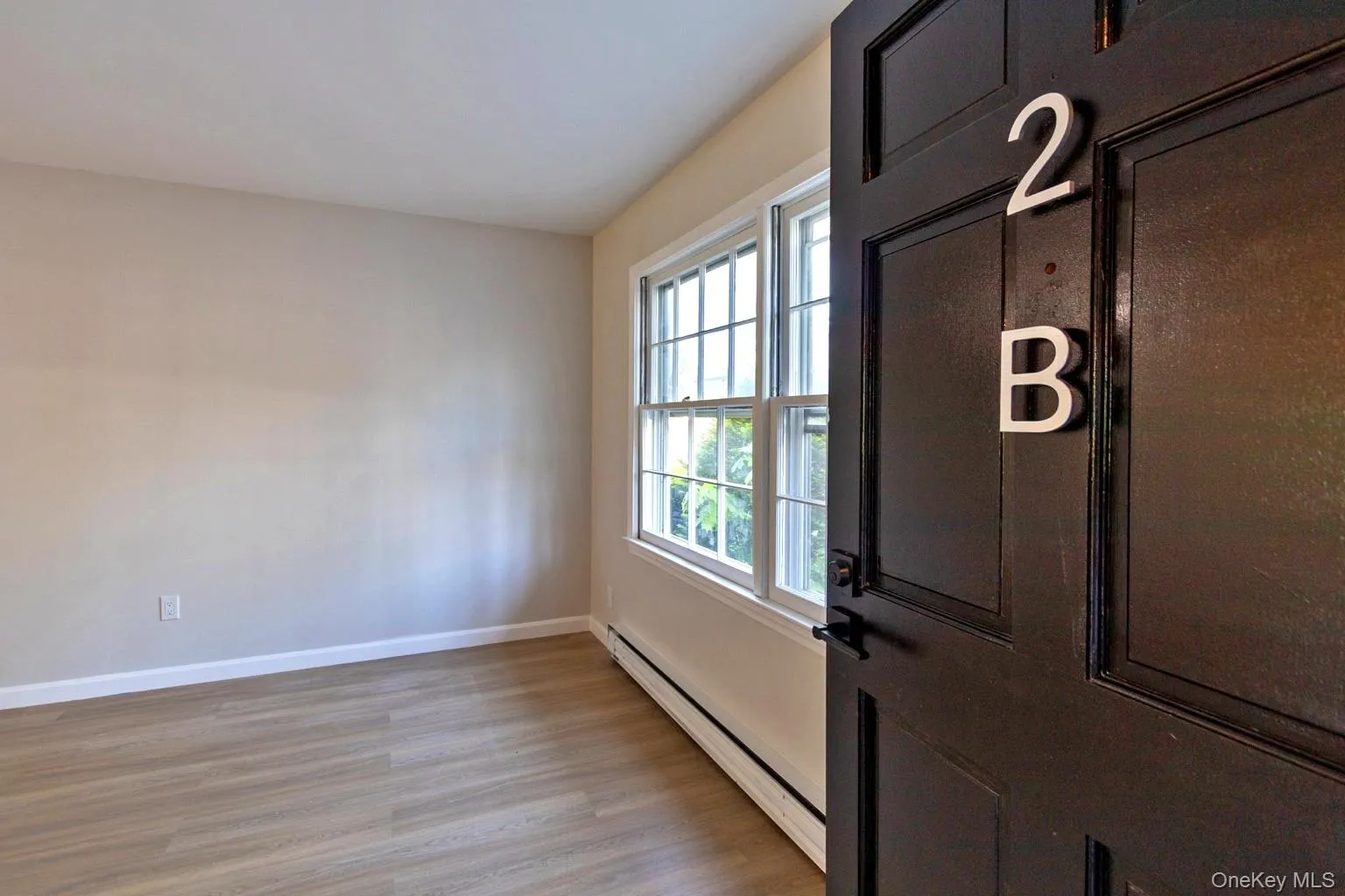 Neutral wall paint, wood-finish flooring, and white baseboards Neutral wall paint, wood-finish flooring, and white baseboards