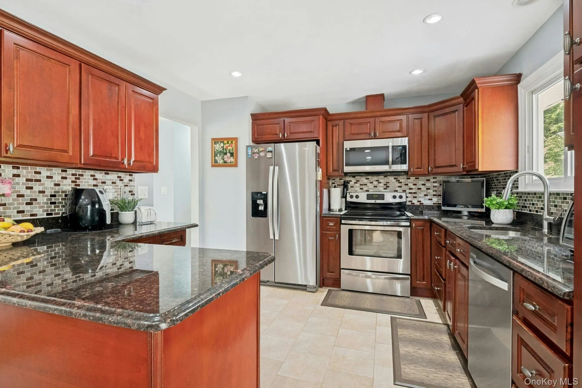Open kitchen with granite countertops and stainless steel appliances Open kitchen with granite countertops and stainless steel appliances