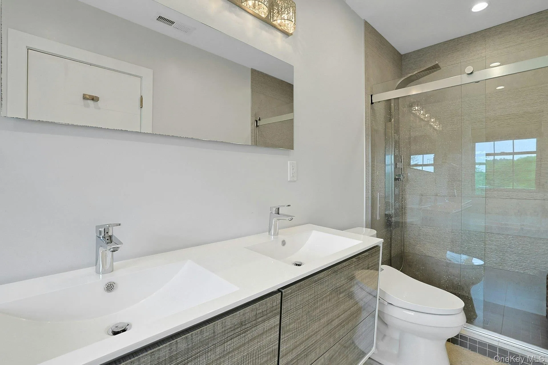 Primary ensuite bathroom with step-in shower and tile surround Primary ensuite bathroom with step-in shower and tile surround