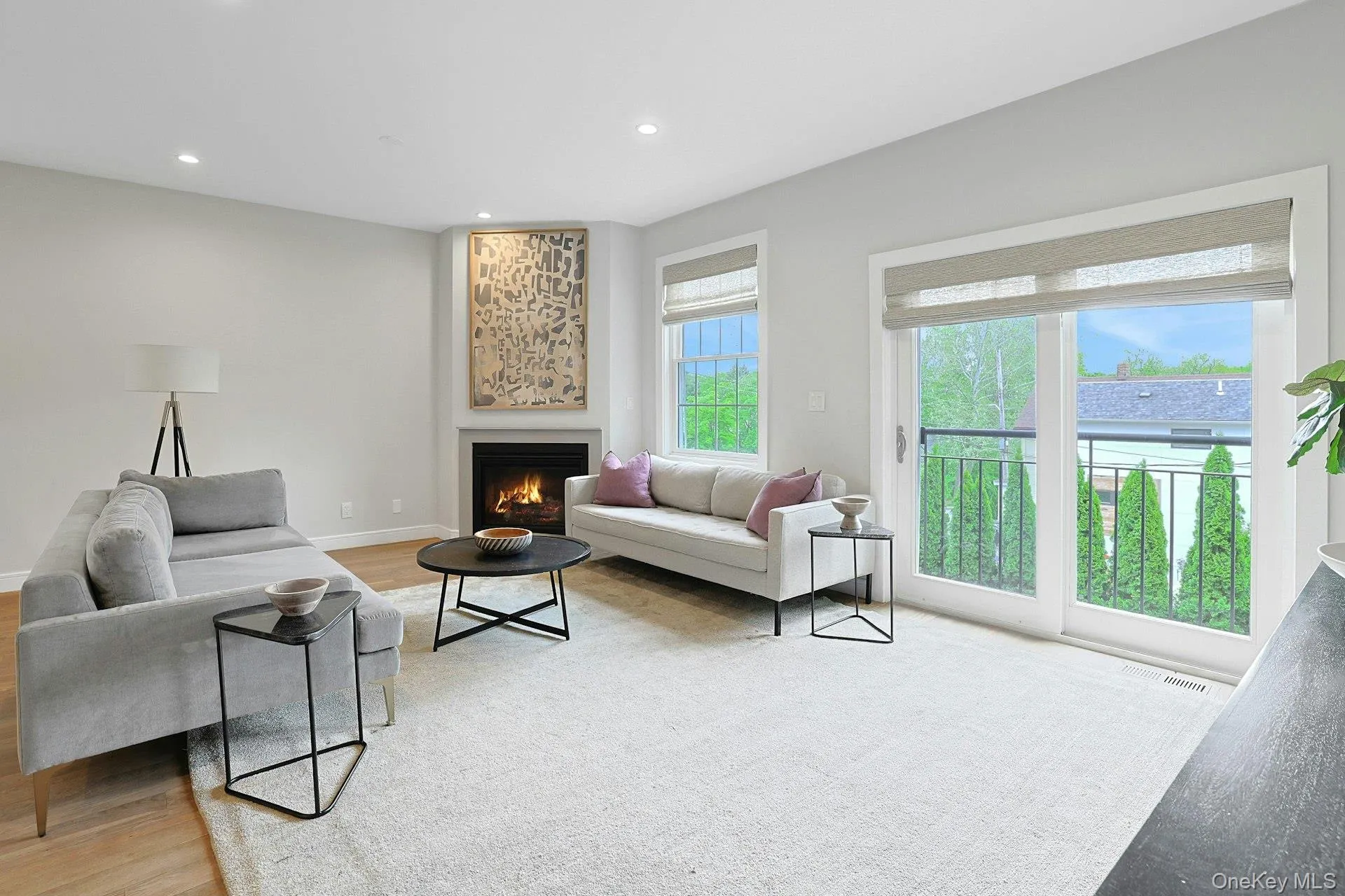 View of the family room with gas fireplace and sliding glass door to a Juliet balcony View of the family room with gas fireplace and sliding glass door to a Juliet balcony