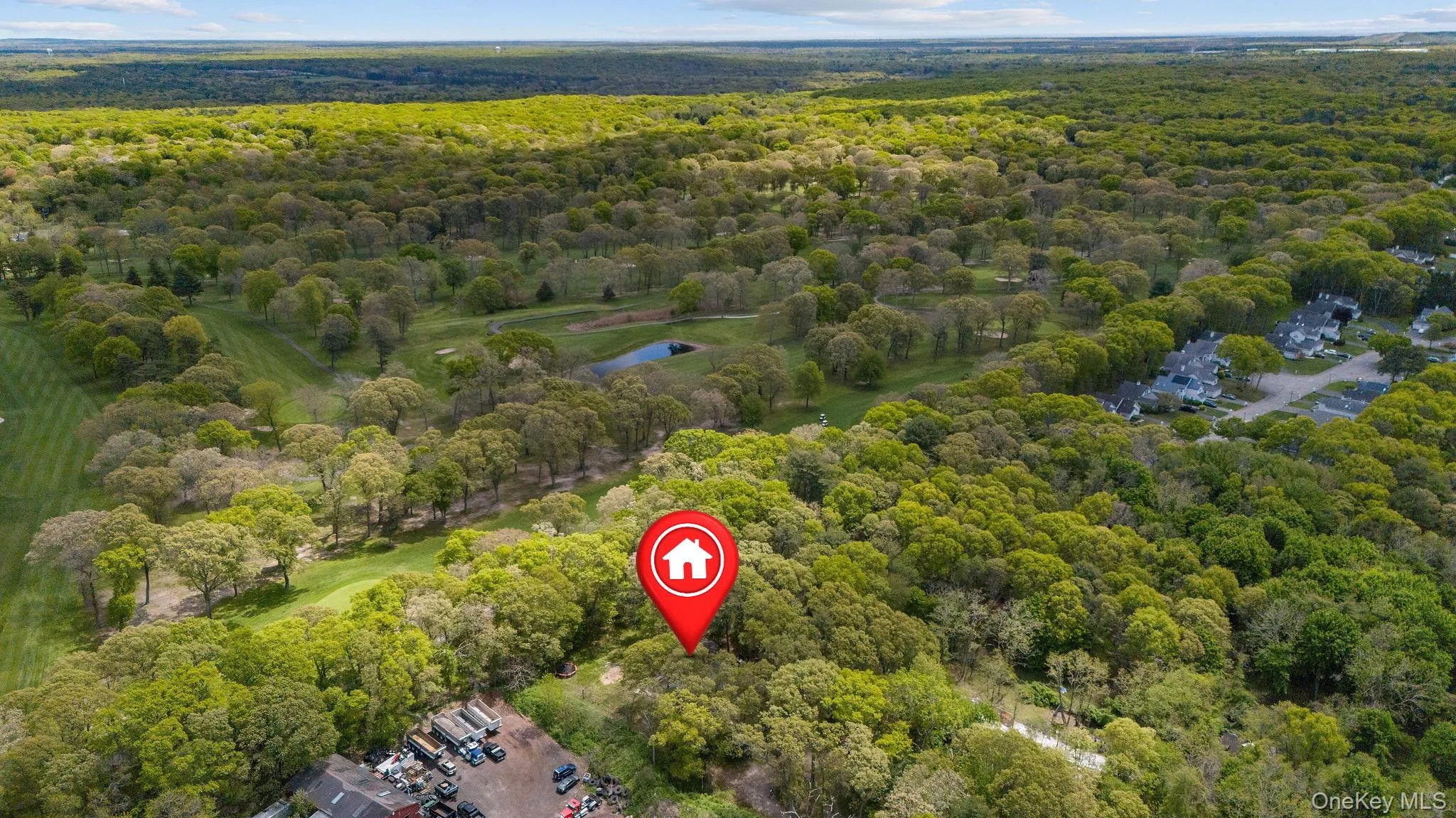 Expansive, verdant landscape featuring a golf course, mature trees, and a residential community Expansive, verdant landscape featuring a golf course, mature trees, and a residential community