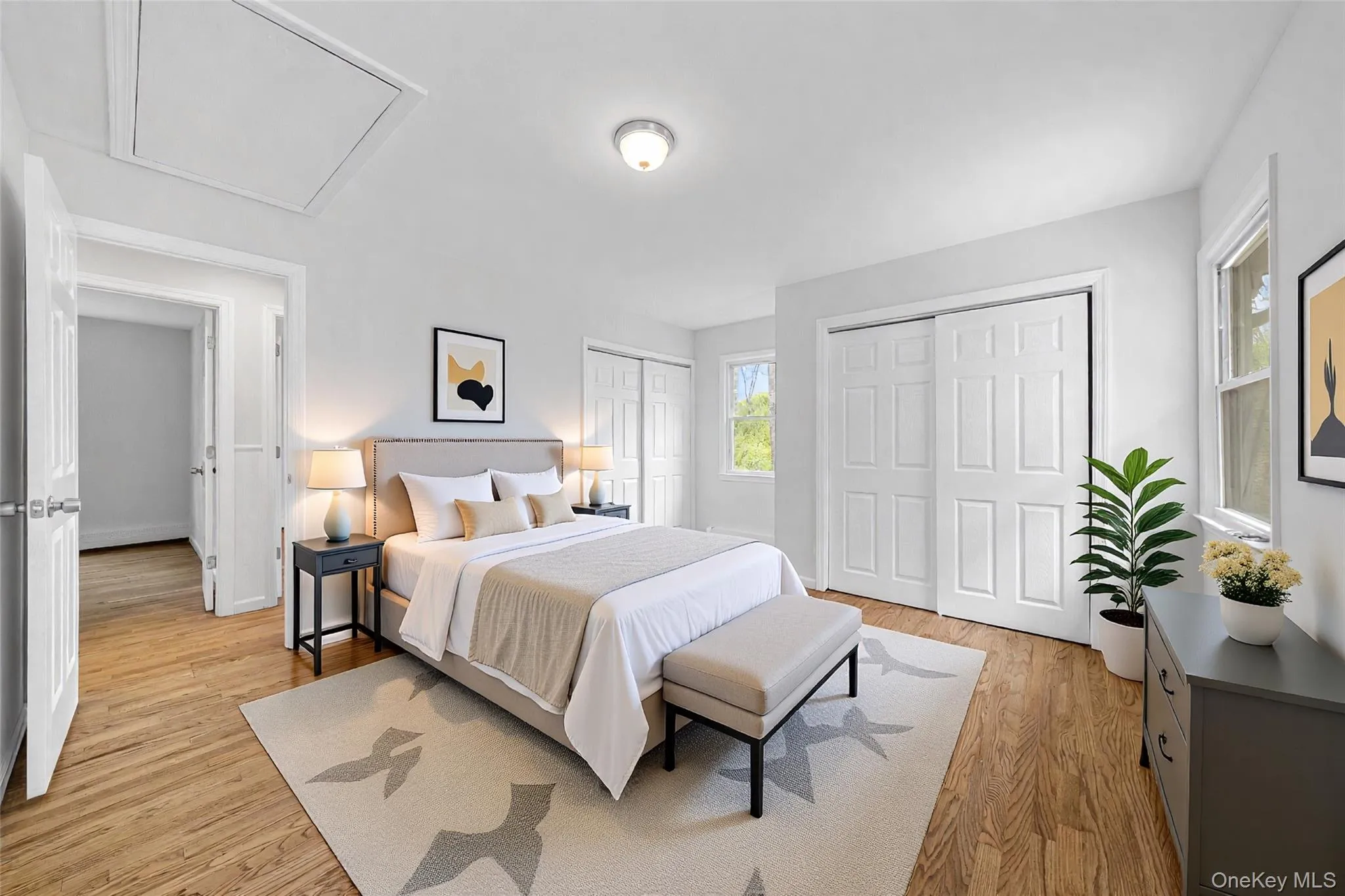 Bright room featuring wood-finish flooring, white walls, and a flush-mount ceiling light. Image is Virtually Staged. Bright room featuring wood-finish flooring, white walls, and a flush-mount ceiling light. Image is Virtually Staged.