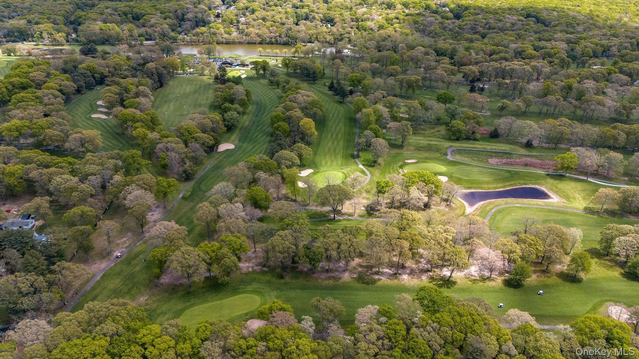 Expansive golf course setting featuring multiple greens, sand traps, and water hazards Expansive golf course setting featuring multiple greens, sand traps, and water hazards