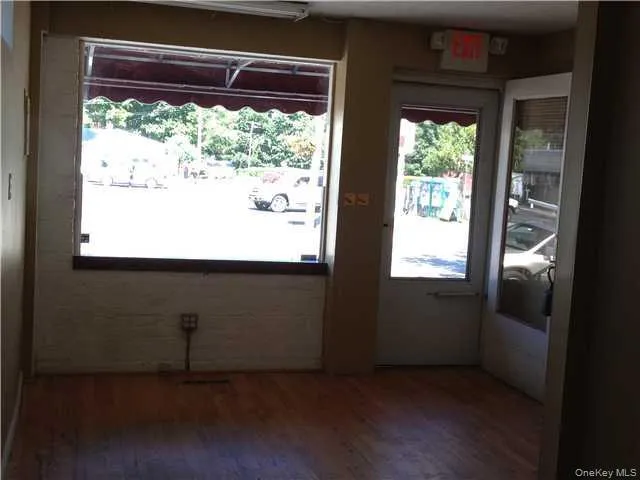 Unit A: Retail/Office space with wood finished floors and large windows Unit A: Retail/Office space with wood finished floors and large windows