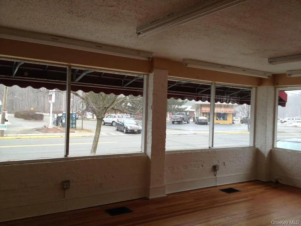 Unit B: Retail/Office space with wood finished floors and large windows Unit B: Retail/Office space with wood finished floors and large windows