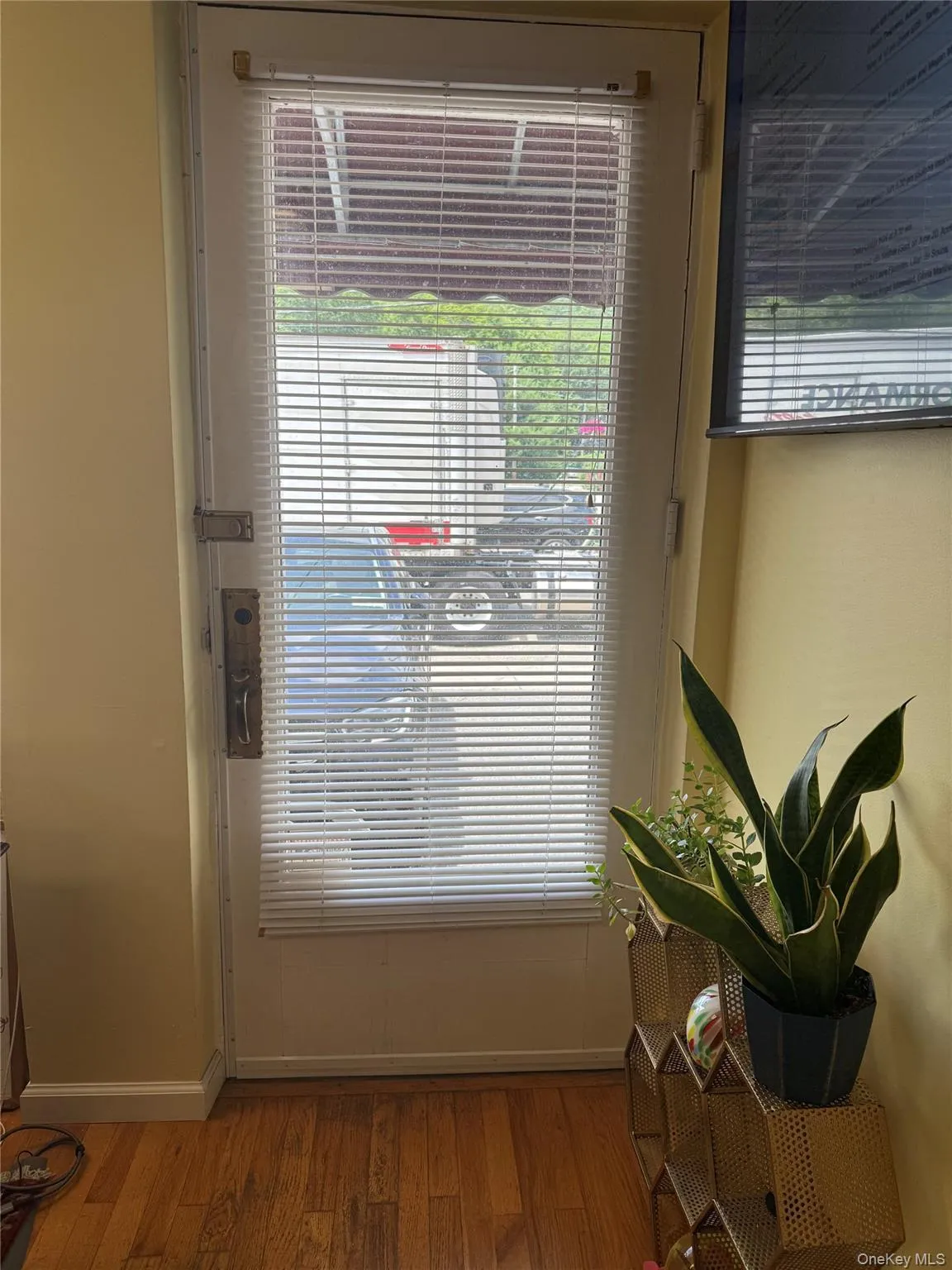 Unit A: Doorway to outside with wood finished floors and plenty of natural light Unit A: Doorway to outside with wood finished floors and plenty of natural light